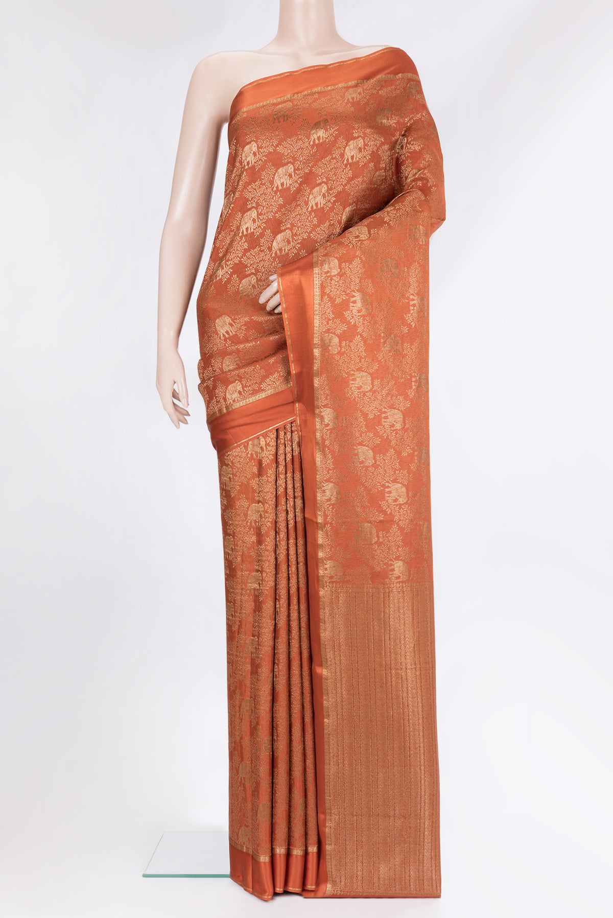 Rust Georgette Saree with Zari Brocade on the body and Zari Border.  displayed on a mannequin
