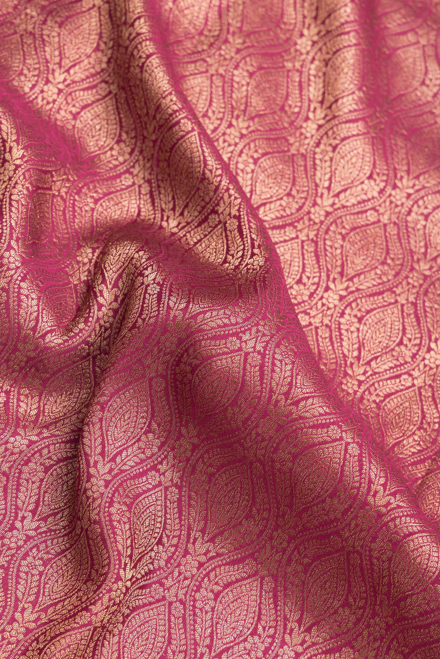 Close up of Magenta Dual Tone Banarasi Georgette Saree with Zari Brocade on the body and Zari Border.  displaying folds