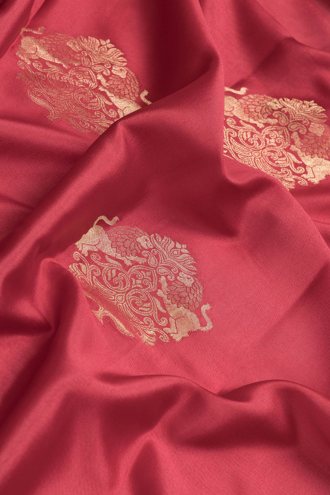 Close up of Maroon Dual Tone Mysore Georgette Saree with Zari Butta on the body and Zari Border.  displaying folds