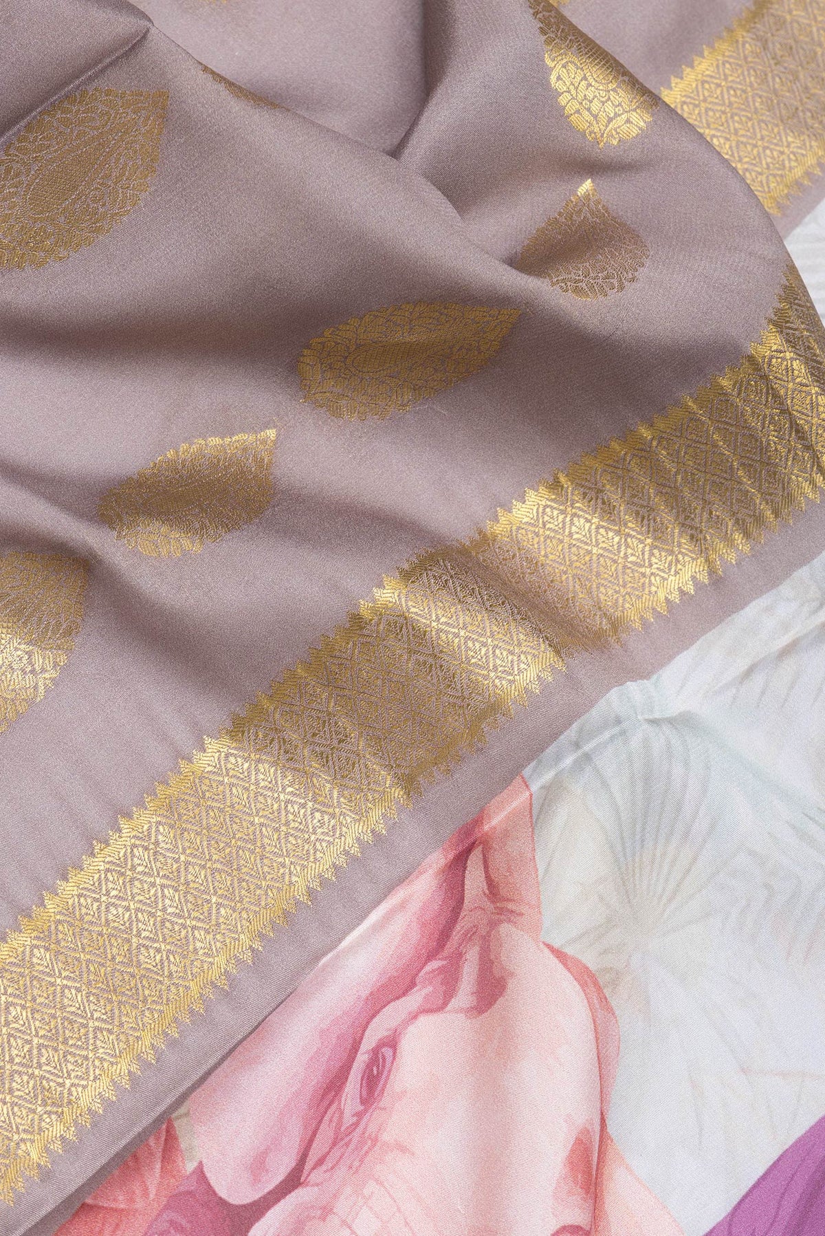 Close up of Grey Mysore Silk Saree with Printed design on the body and Zari Border.  displaying folds