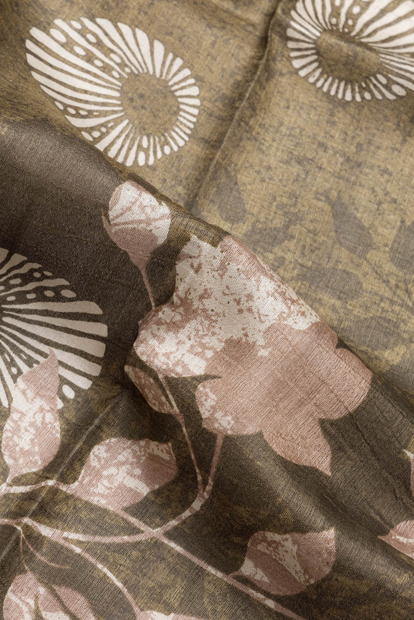 Close up of Mehandi Green Dual Tone Tussar Silk Saree with Printed design on the body and Zari Border.  displaying folds