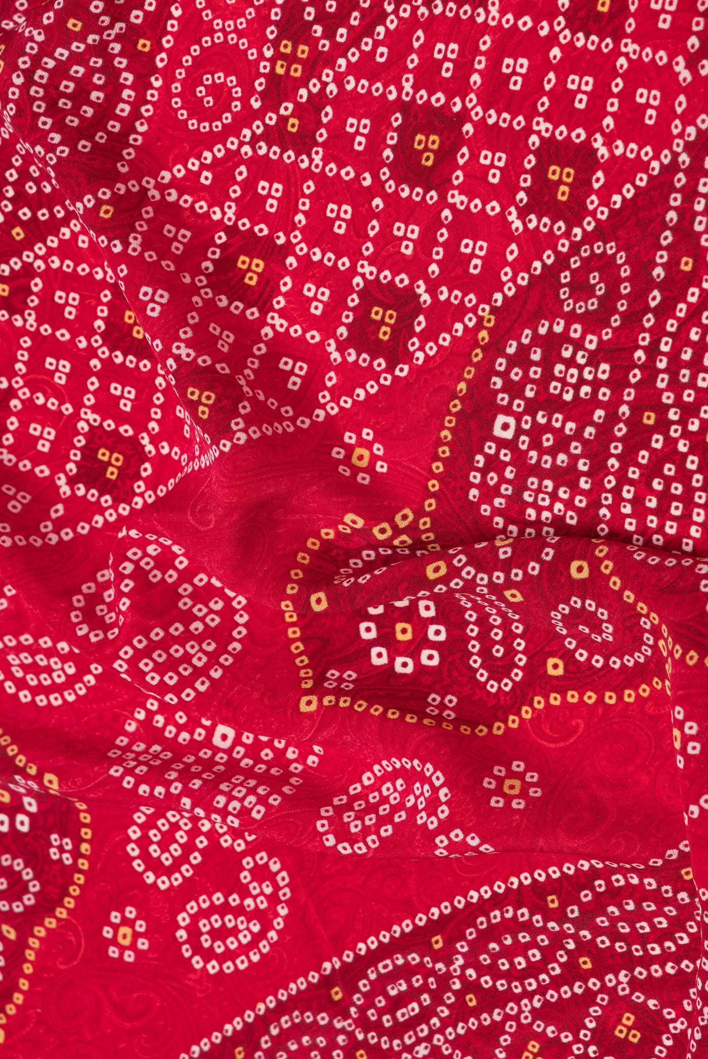 Close up of Red Dual Tone Mysore Crepe Saree with Printed design on the body and Printed Border.  displaying folds