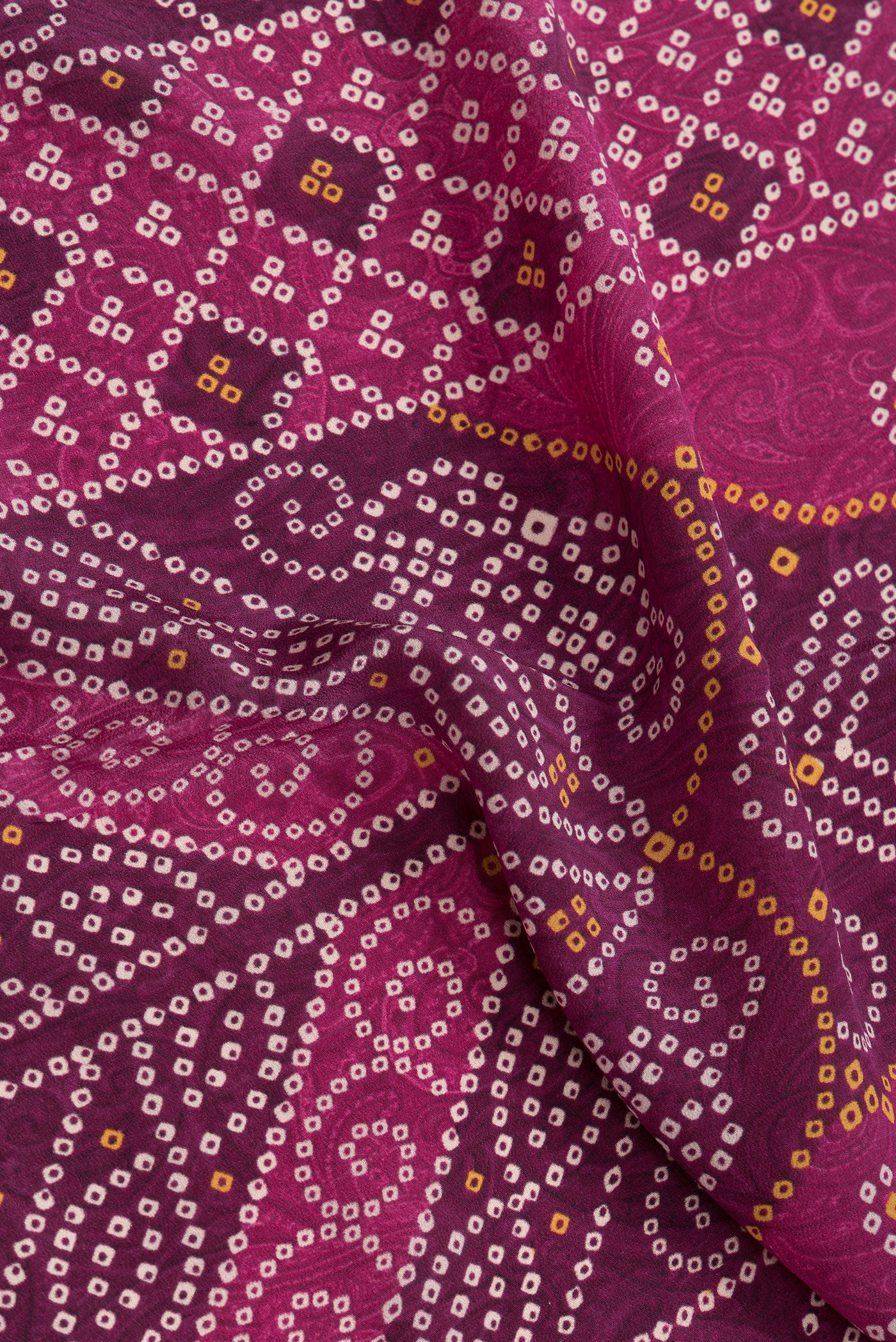Close up of Pink Dual Tone Mysore Crepe Saree with Bandhani Print on the body and Printed Border.  displaying folds