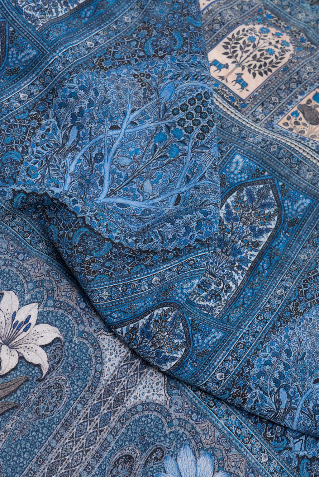 Close up of Grey Dual Tone Crepe Saree with Printed design on the body and Printed Border.  displaying folds