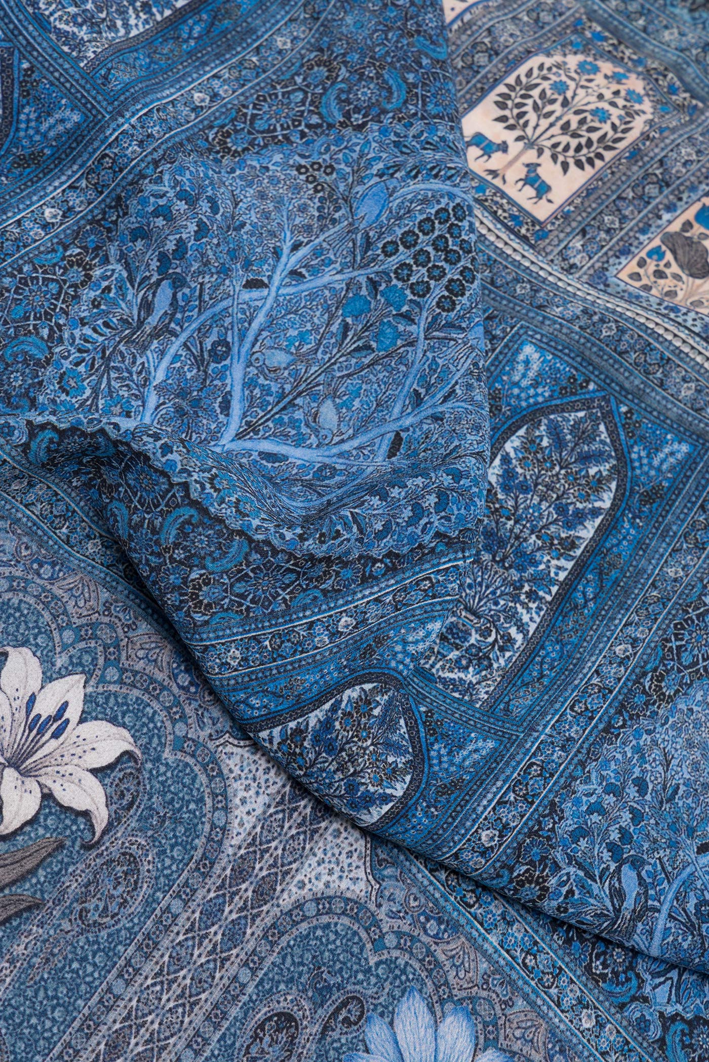 Close up of Grey Dual Tone Crepe Saree with Printed design on the body and Printed Border.  displaying folds