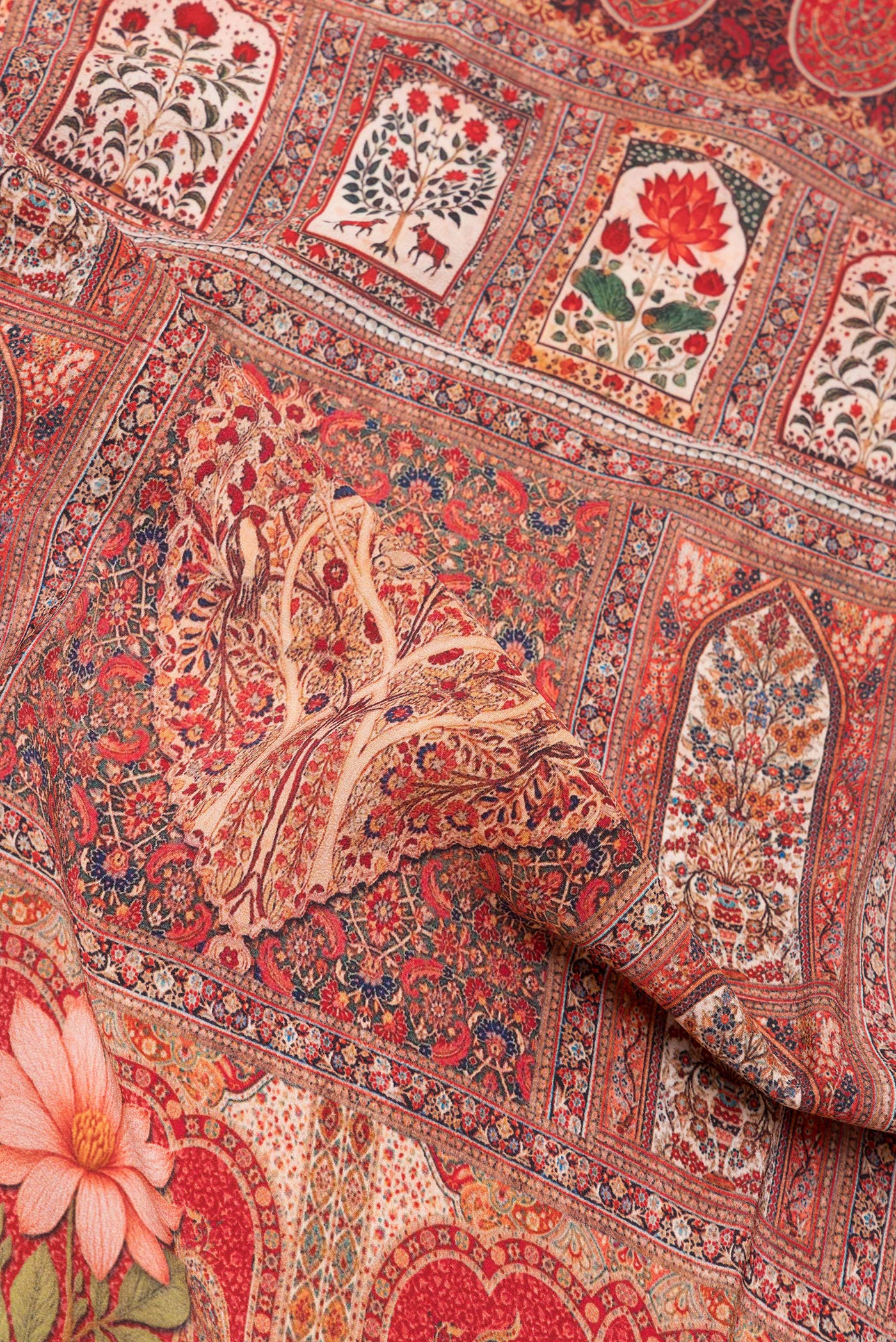 Close up of Red Crepe Saree with Printed design on the body and Printed Border.  displaying folds