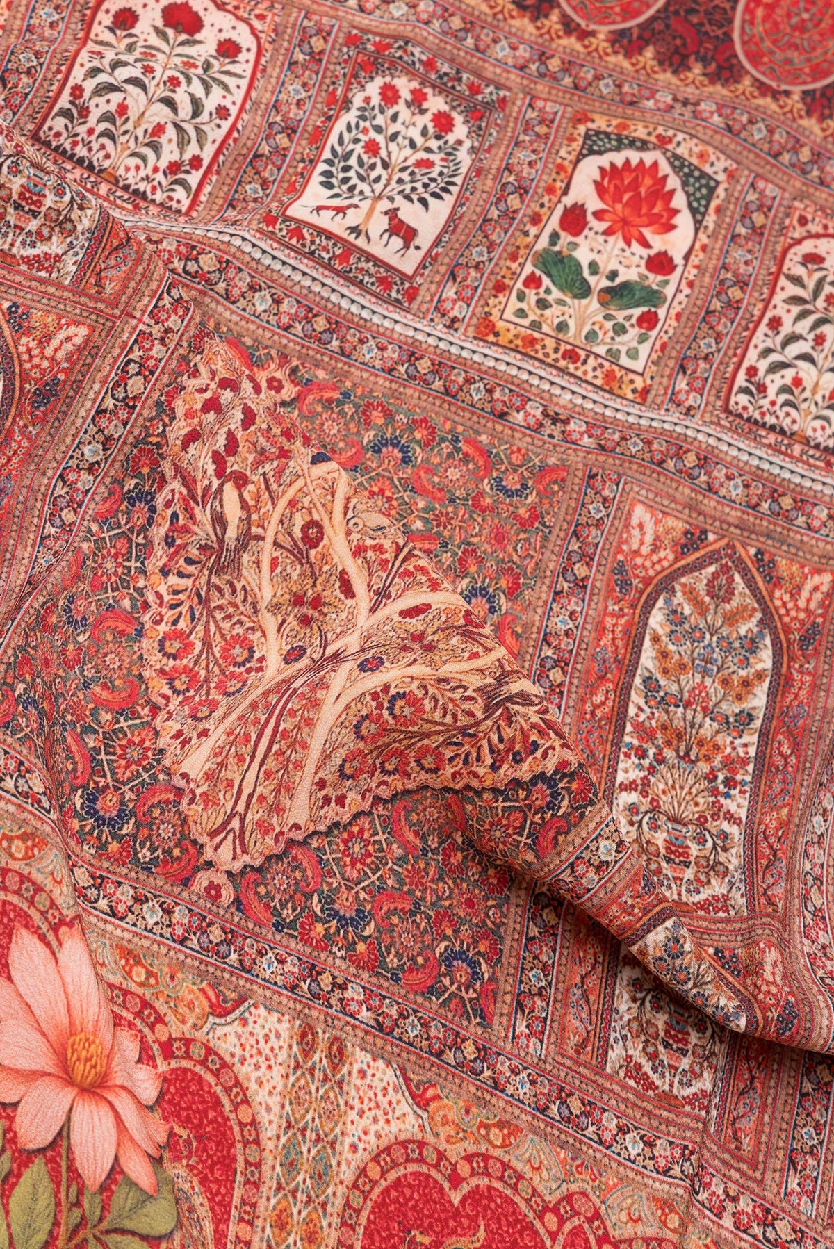 Close up of Red Crepe Saree with Printed design on the body and Printed Border.  displaying folds