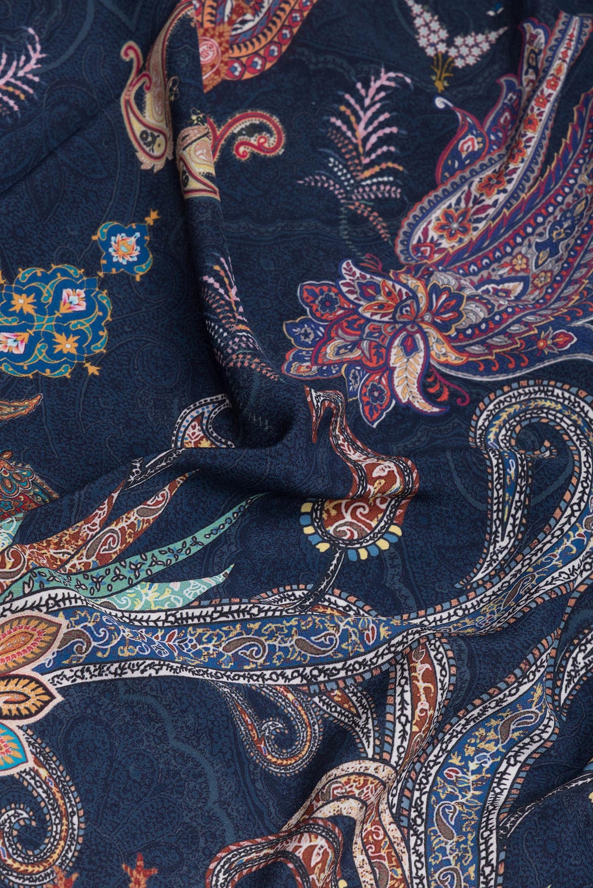 Close up of Navy Blue Crepe Saree with Printed design on the body and Plain Border.  displaying folds