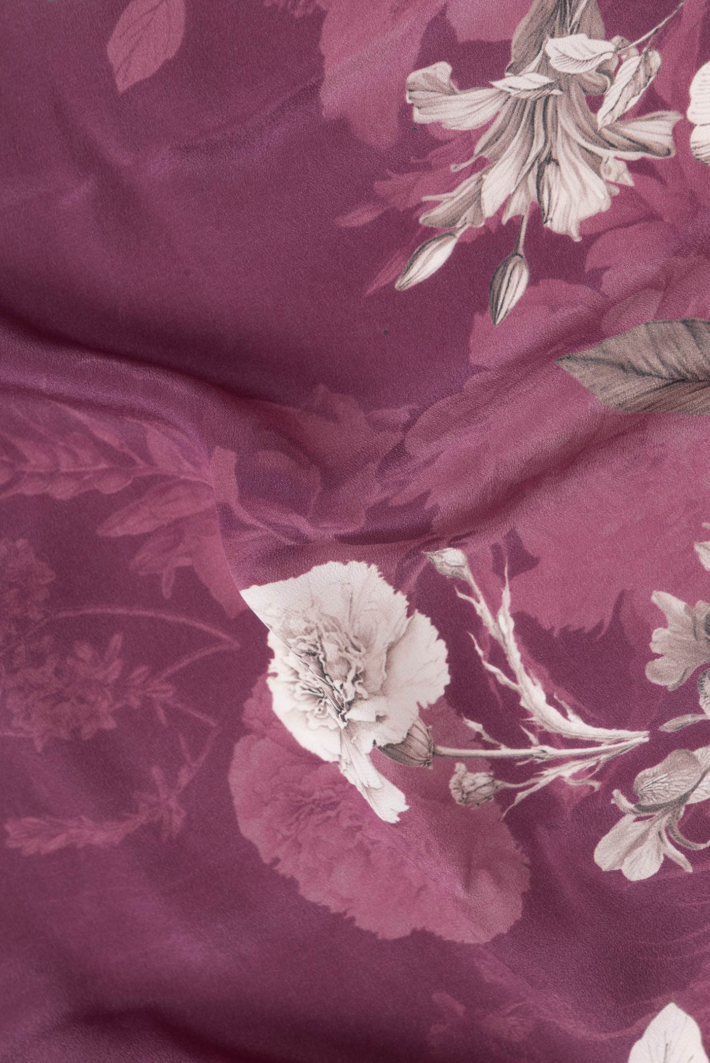 Close up of Magenta Dual Tone Mysore Crepe Saree with Printed design on the body and Without Border.  displaying folds