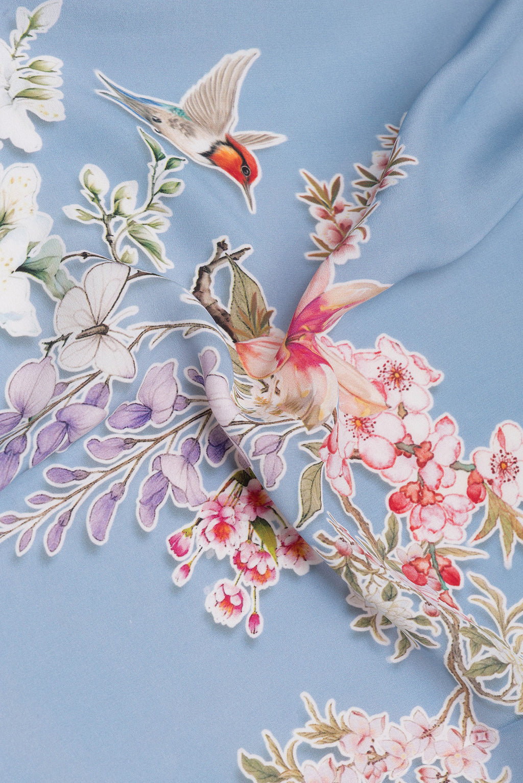 Close up of Light Blue Crepe Saree with Printed design on the body and Without Border.  displaying folds