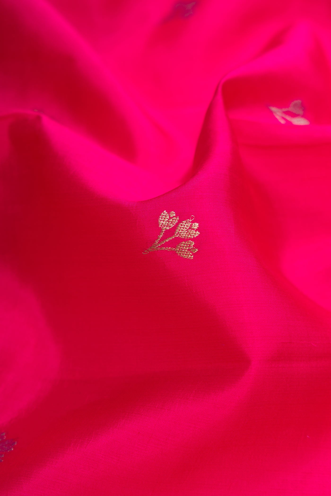 Close up of Pink Dual Tone Tussar Silk Saree with Zari Butta on the body and Fancy Border.  displaying folds