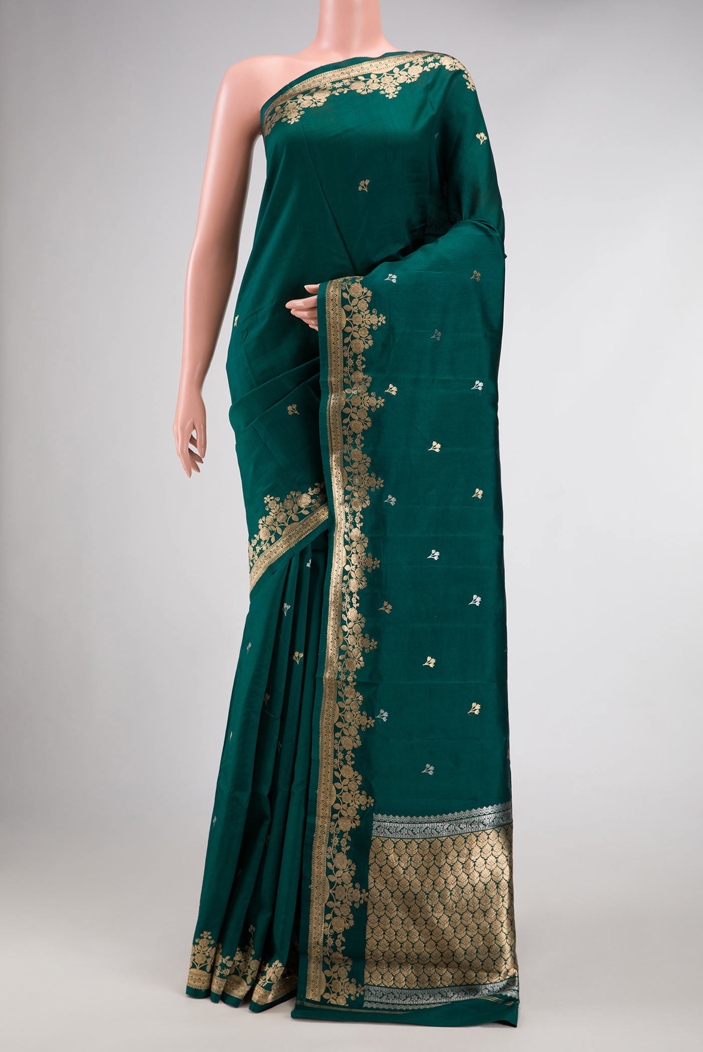 Bottle Green Dual Tone Tussar Silk Saree with Zari Butta on the body and Fancy Border.  displayed on a mannequin