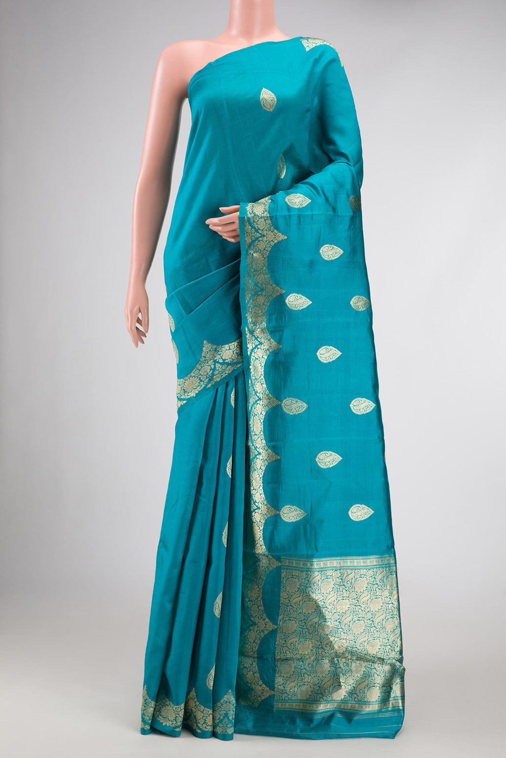 Peacock Blue Dual Tone Tussar Silk Saree with Zari Butta on the body and Fancy Border.  displayed on a mannequin