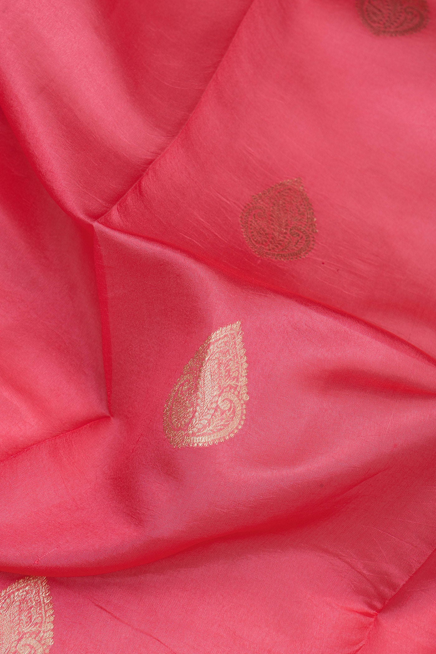 Close up of Golden Peach Dual Tone Tussar Silk Saree with Zari Butta on the body and Fancy Border.  displaying folds