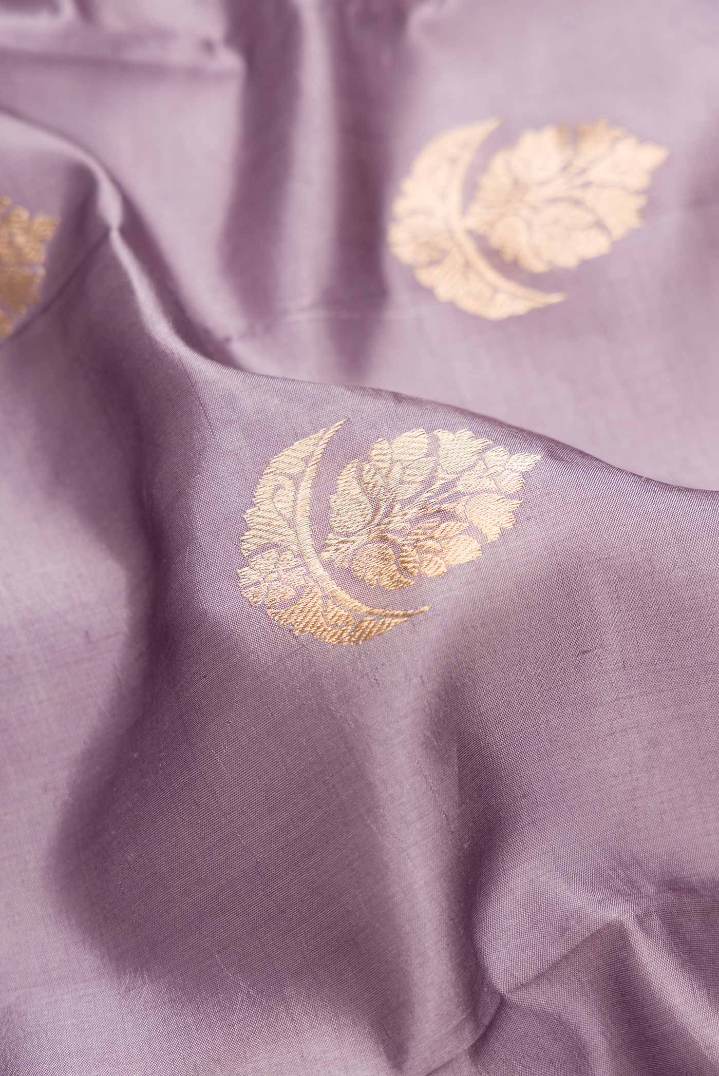 Close up of Purple Dual Tone Tussar Silk Saree with Zari Butta on the body and Fancy Border.  displaying folds