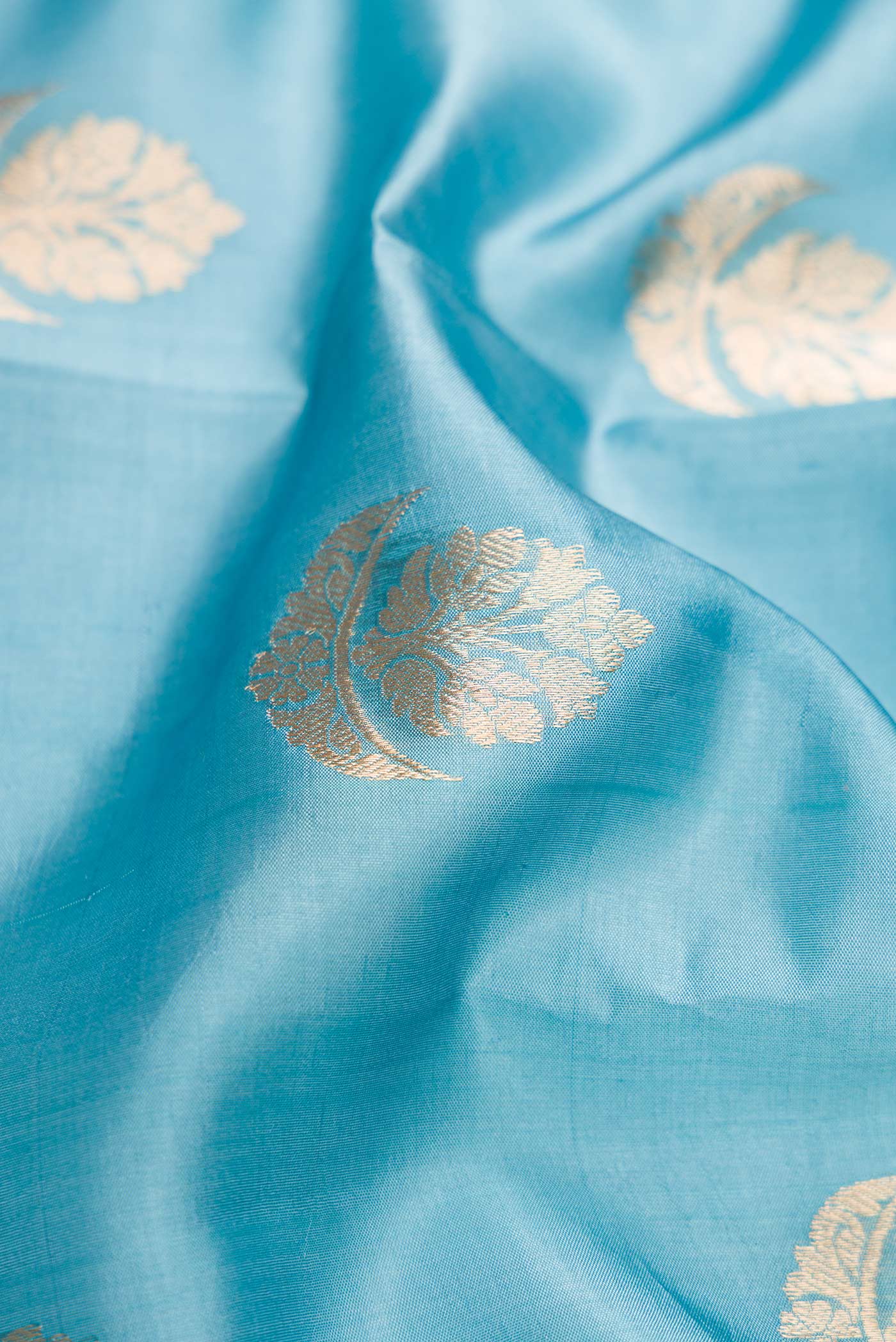 Close up of Grey Dual Tone Tussar Silk Saree with Zari Butta on the body and Fancy Border.  displaying folds