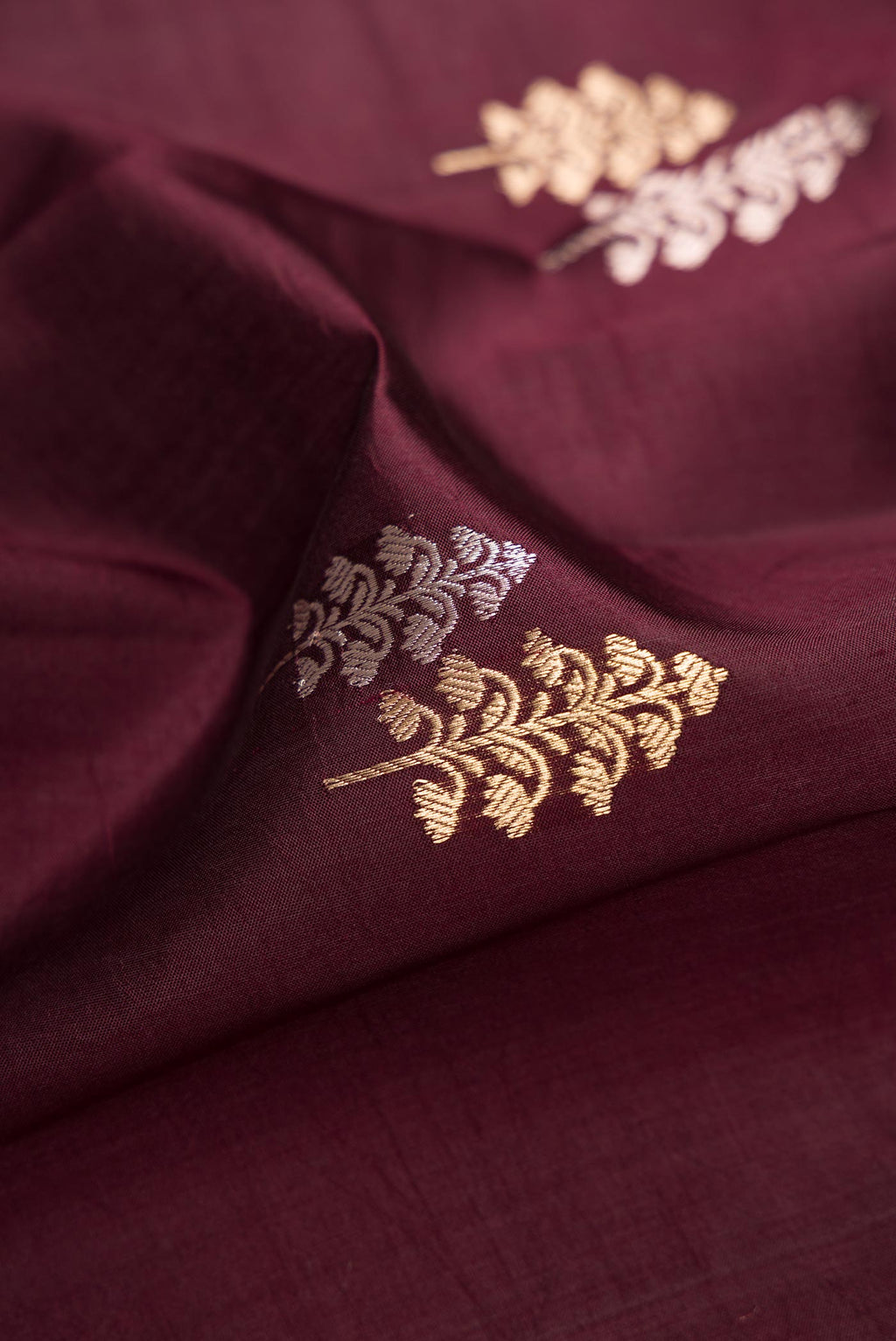 Close up of Coffee Brown Dual Tone Tussar Silk Saree with Zari Butta on the body and Fancy Border.  displaying folds