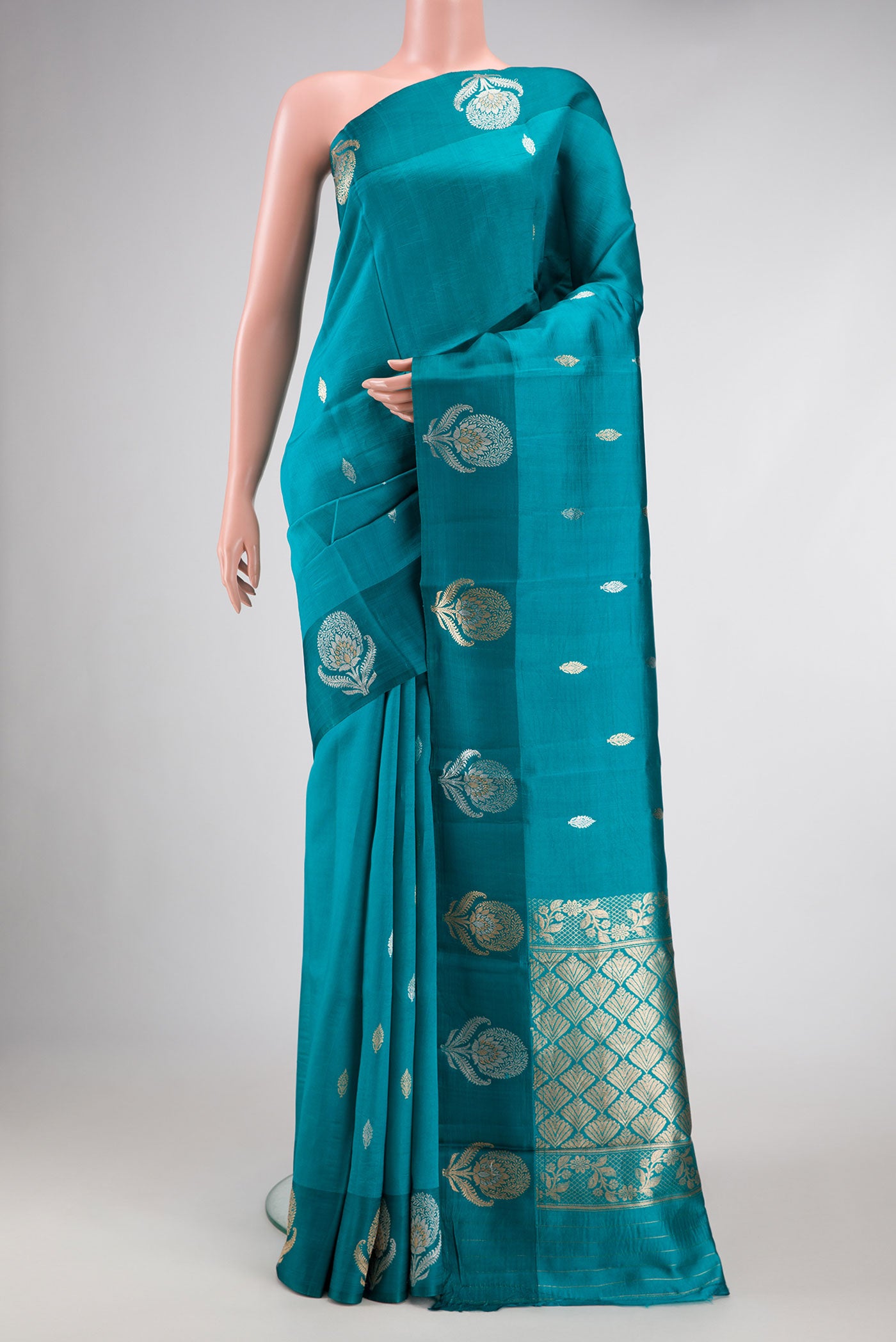 Peacock Blue Dual Tone Tussar Silk Saree with Zari Butta on the body and Fancy Border.  displayed on a mannequin