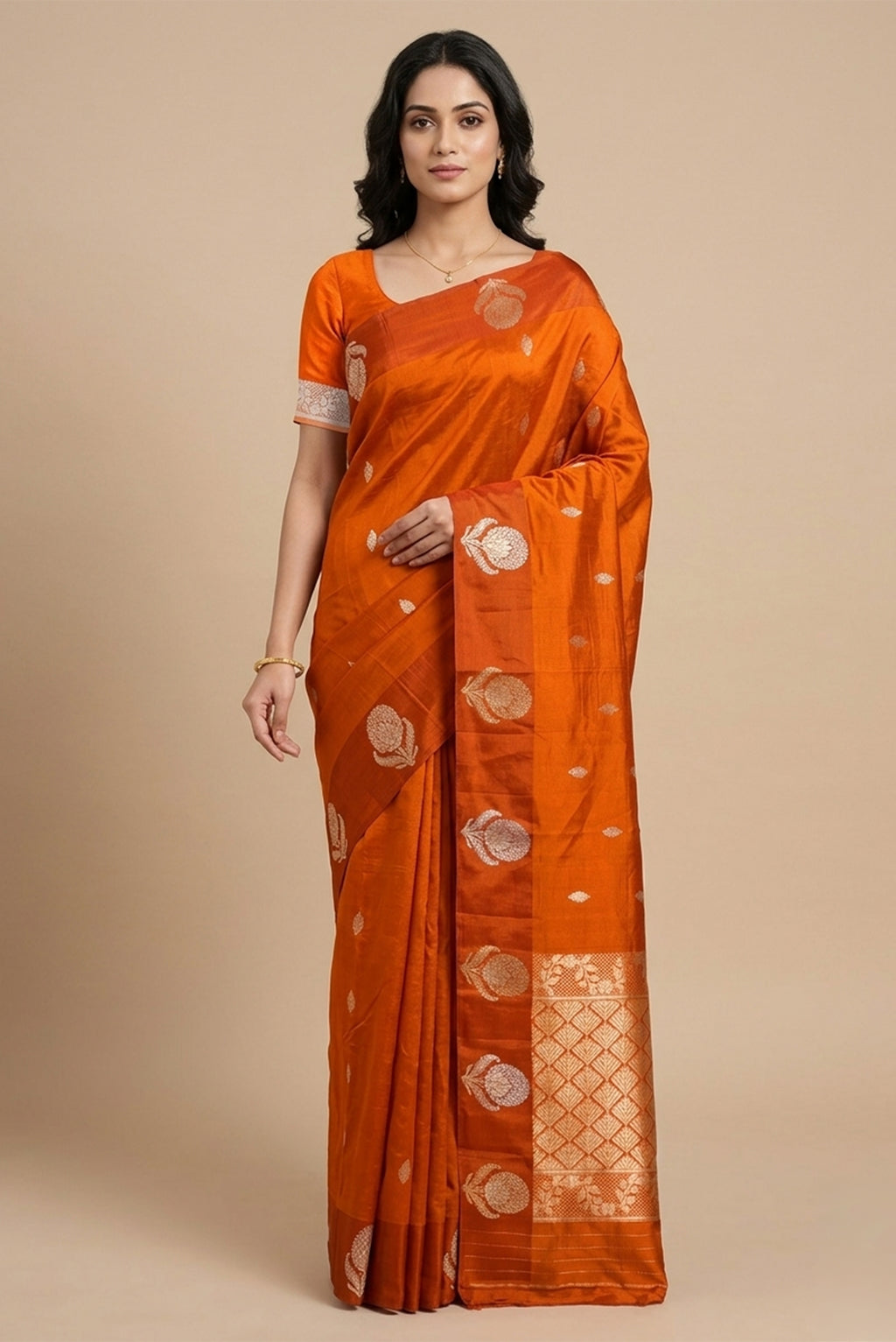 Model wearing a Orange Banarasi Katan Silk Saree with Zari Butta on the body and Satin Border.