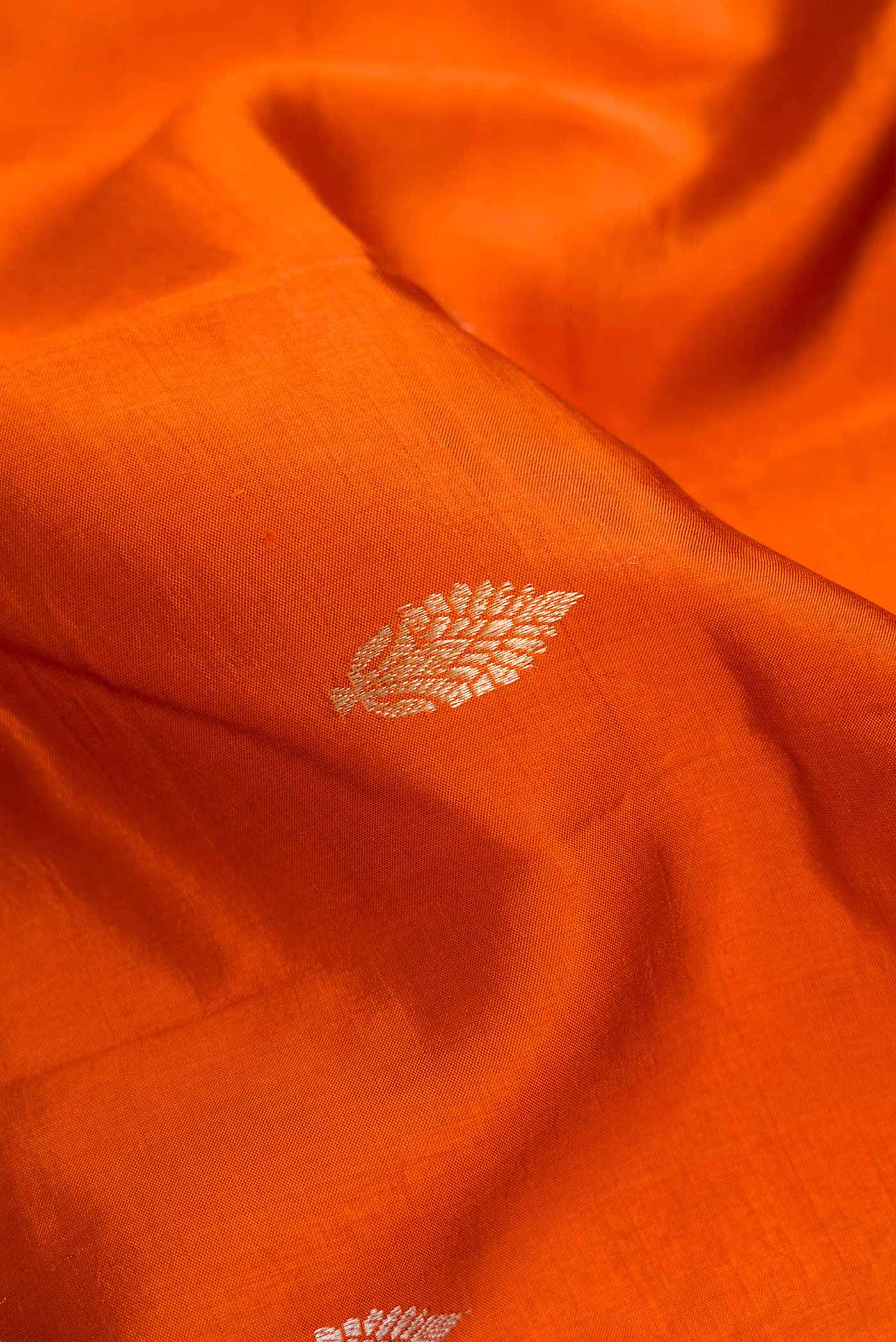 Close up of Orange Dual Tone Tussar Silk Saree with Zari Butta on the body and Fancy Border.  displaying folds