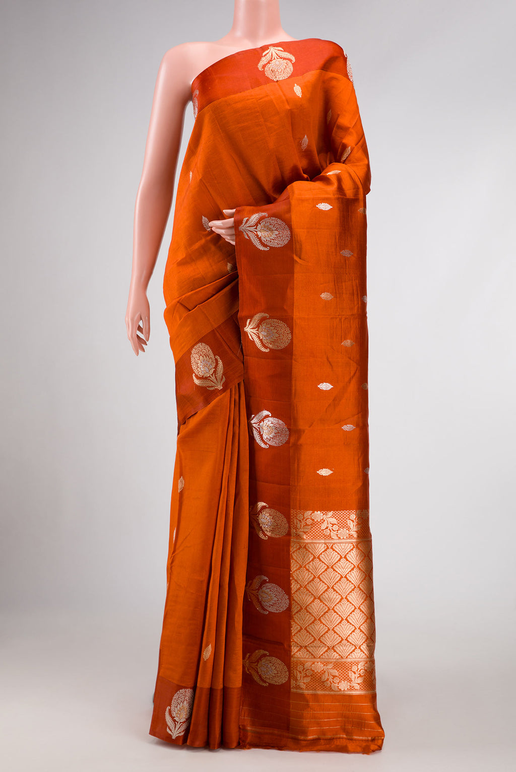 Orange Dual Tone Tussar Silk Saree with Zari Butta on the body and Fancy Border.  displayed on a mannequin