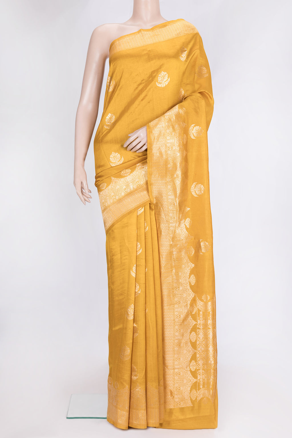 Mustard Dual Tone Tussar Silk Saree with Zari Butta on the body and Fancy Border.  displayed on a mannequin