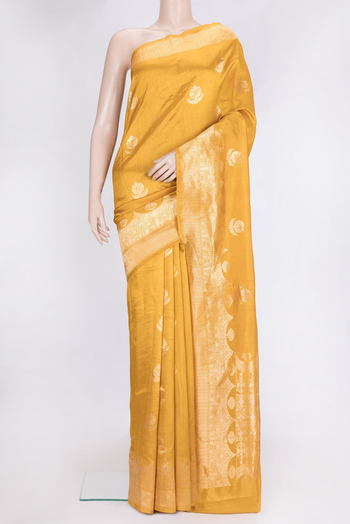 Mustard Dual Tone Tussar Silk Saree with Zari Butta on the body and Fancy Border.  displayed on a mannequin