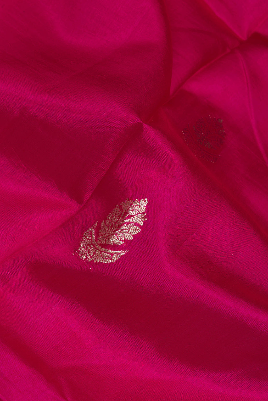 Close up of Dark Pink Dual Tone Tussar Silk Saree with Zari Butta on the body and Zari Border.  displaying folds