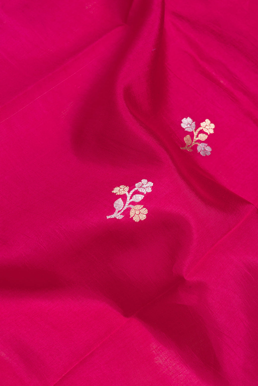 Close up of Pink Dual Tone Tussar Silk Saree with Zari Butta on the body and Fancy Border.  displaying folds