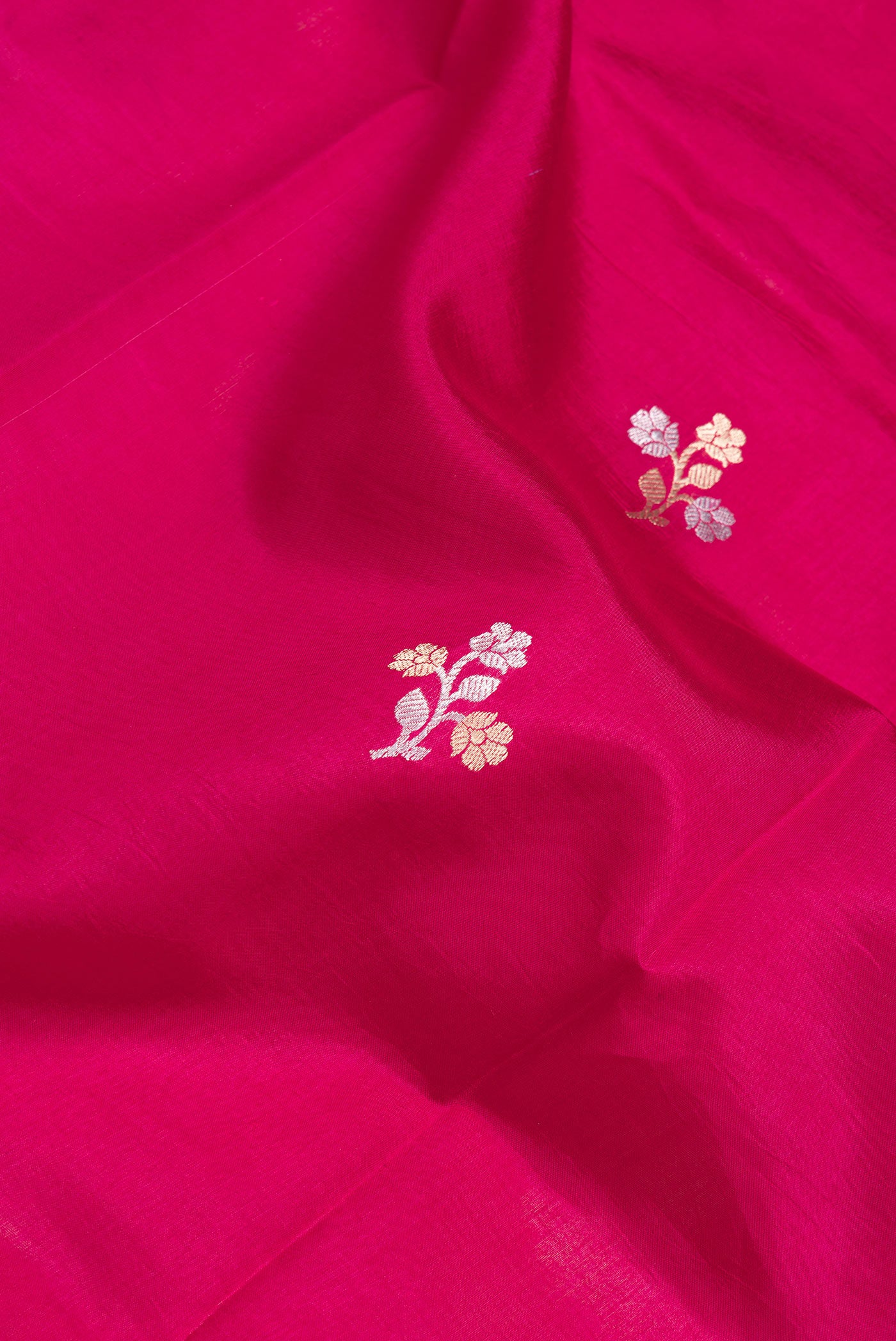 Close up of Pink Dual Tone Tussar Silk Saree with Zari Butta on the body and Fancy Border.  displaying folds