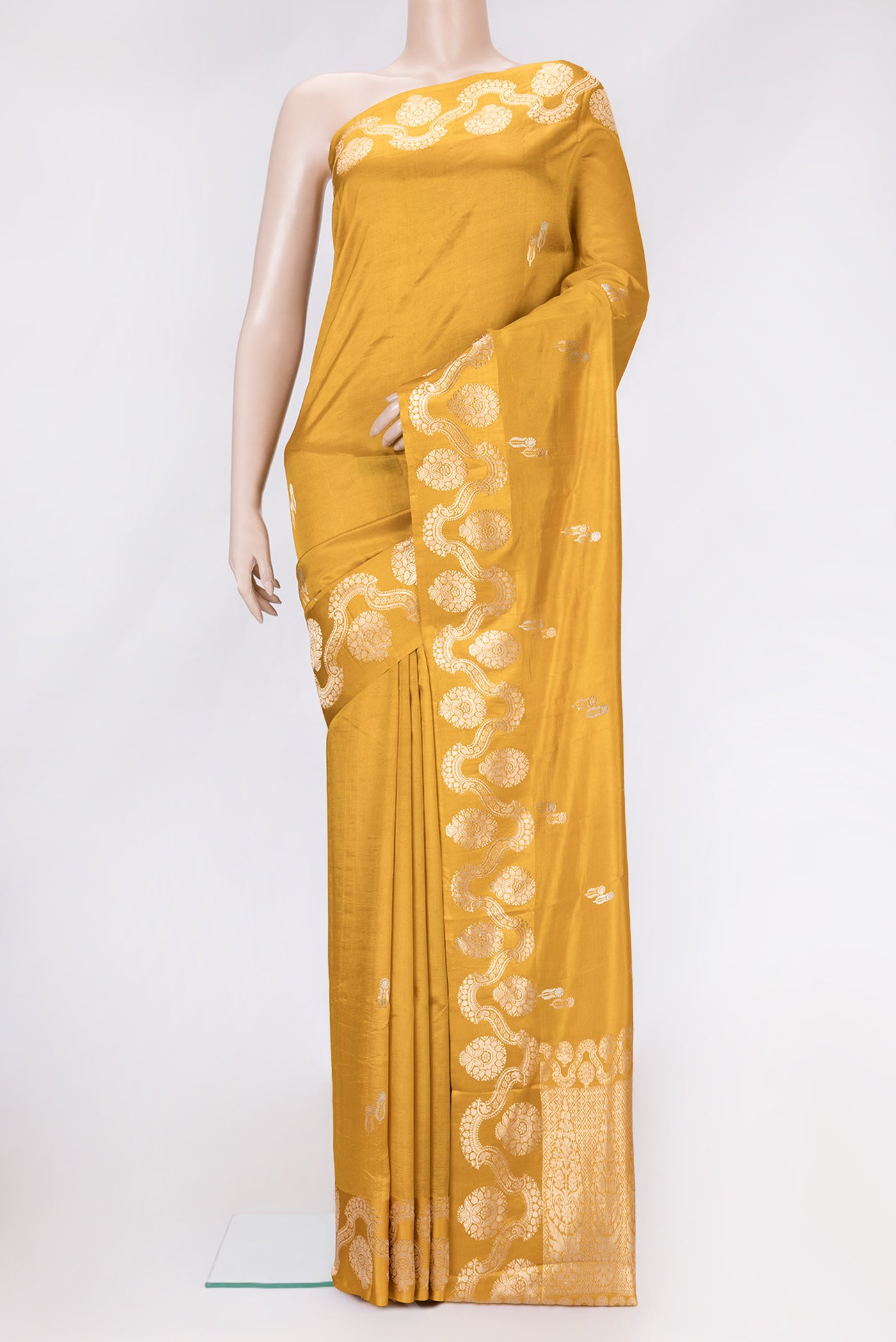 Mustard Dual Tone Tussar Silk Saree with Zari Butta on the body and Fancy Border.  displayed on a mannequin
