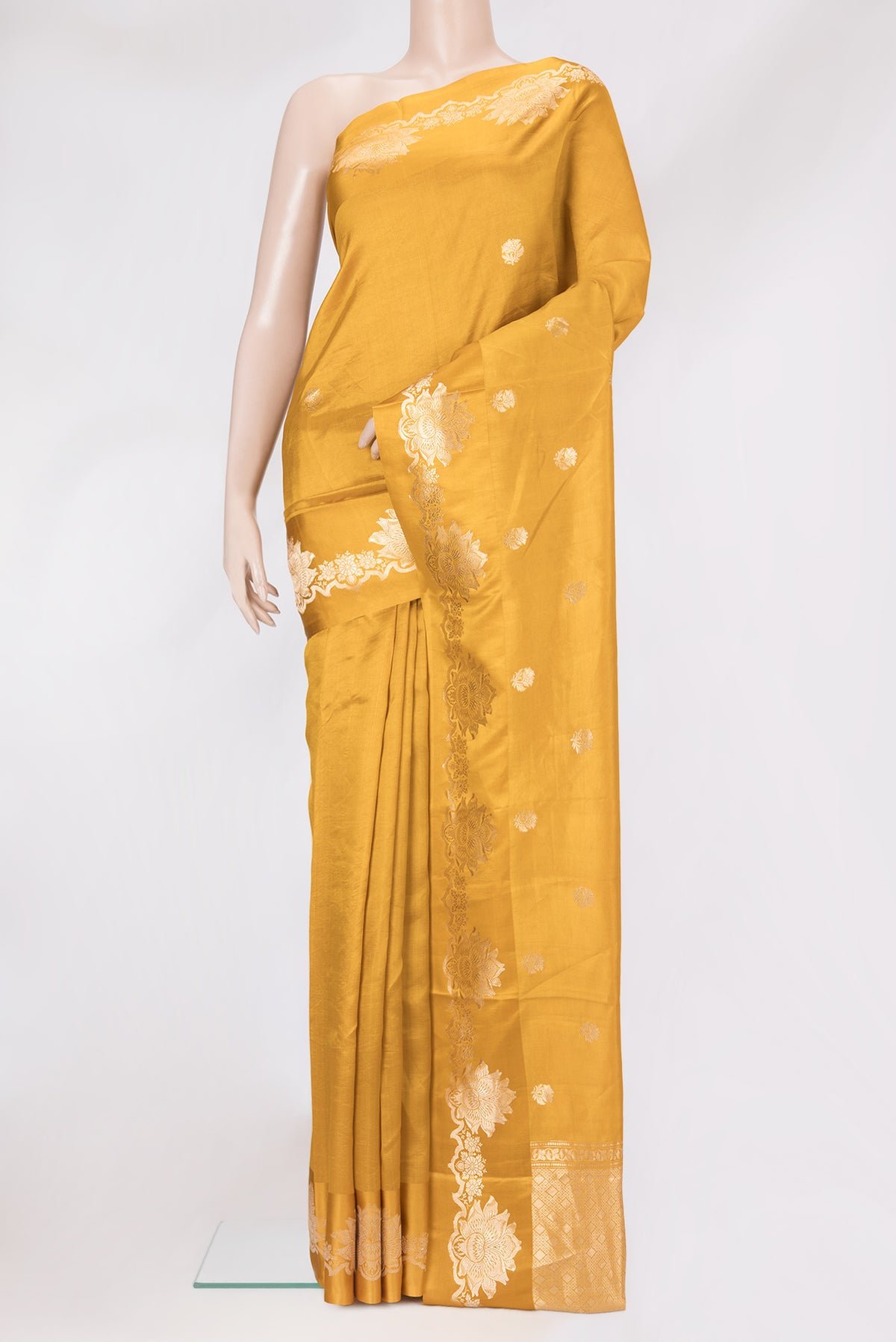 Mustard Dual Tone Tussar Silk Saree with Zari Butta on the body and Fancy Border.  displayed on a mannequin