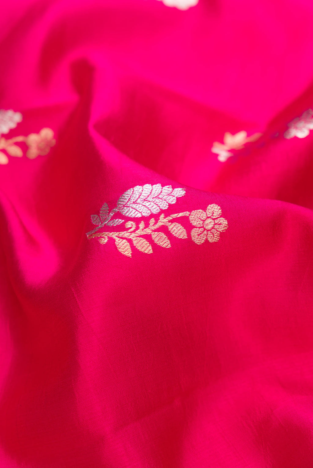 Close up of Pink Dual Tone Tussar Silk Saree with Zari Butta on the body and Fancy Border.  displaying folds