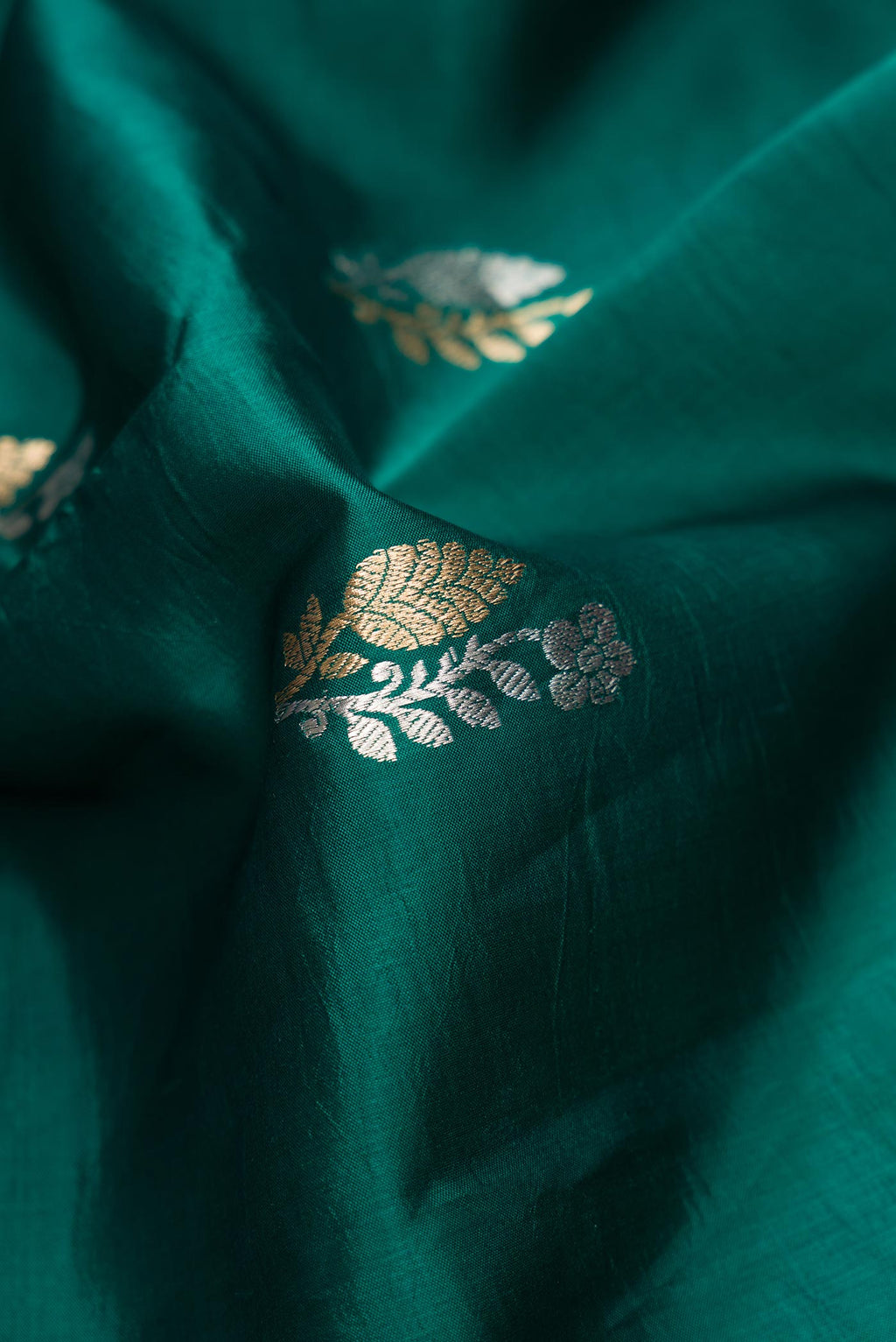 Close up of Bottle Green Dual Tone Tussar Silk Saree with Zari Butta on the body and Fancy Border.  displaying folds