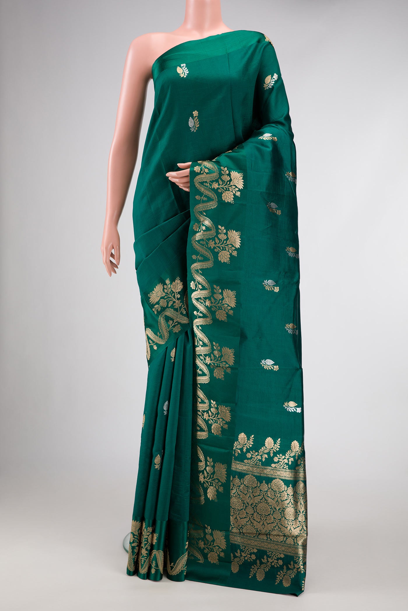 Bottle Green Dual Tone Tussar Silk Saree with Zari Butta on the body and Fancy Border.  displayed on a mannequin