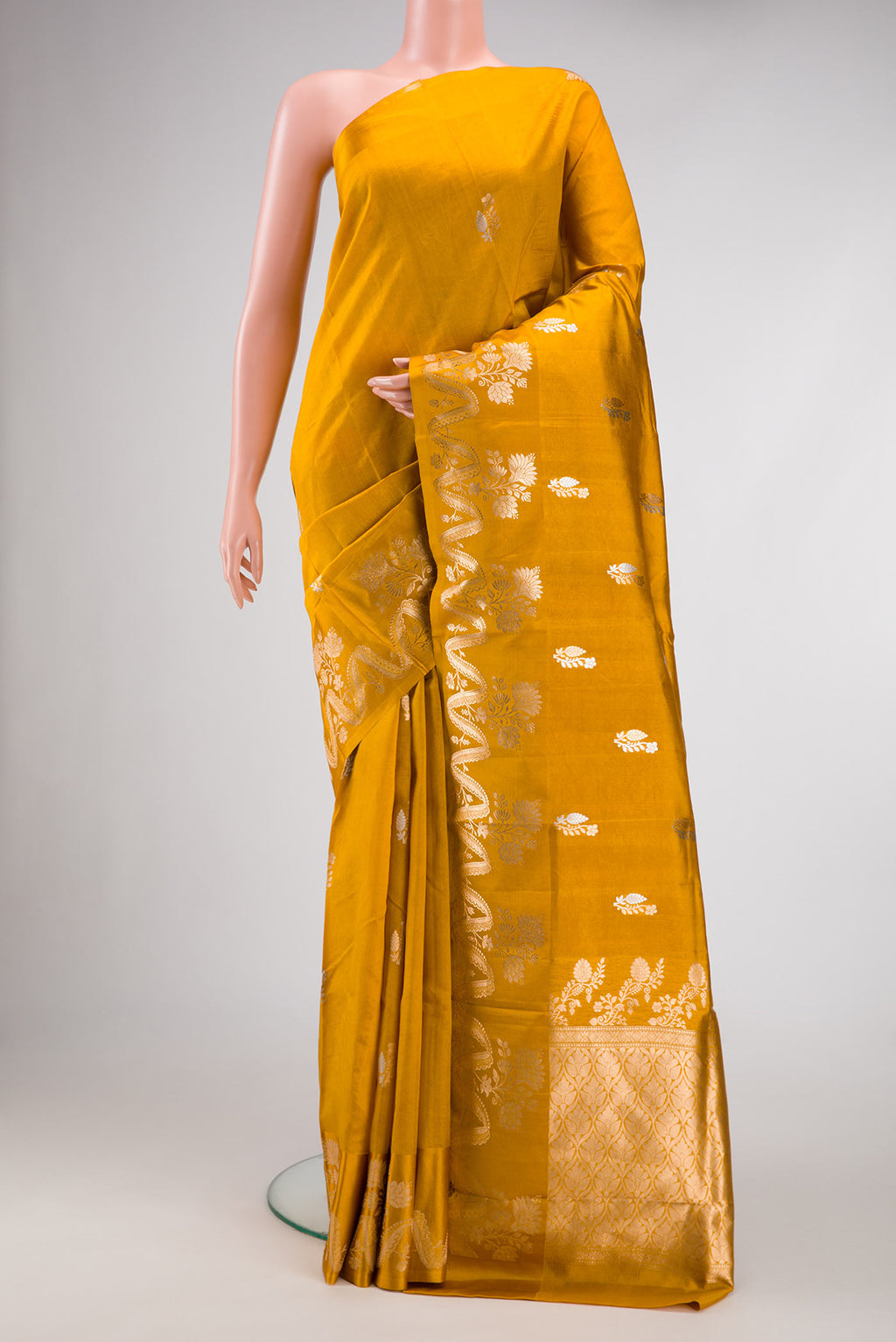 Mustard Dual Tone Tussar Silk Saree with Zari Butta on the body and Fancy Border.  displayed on a mannequin