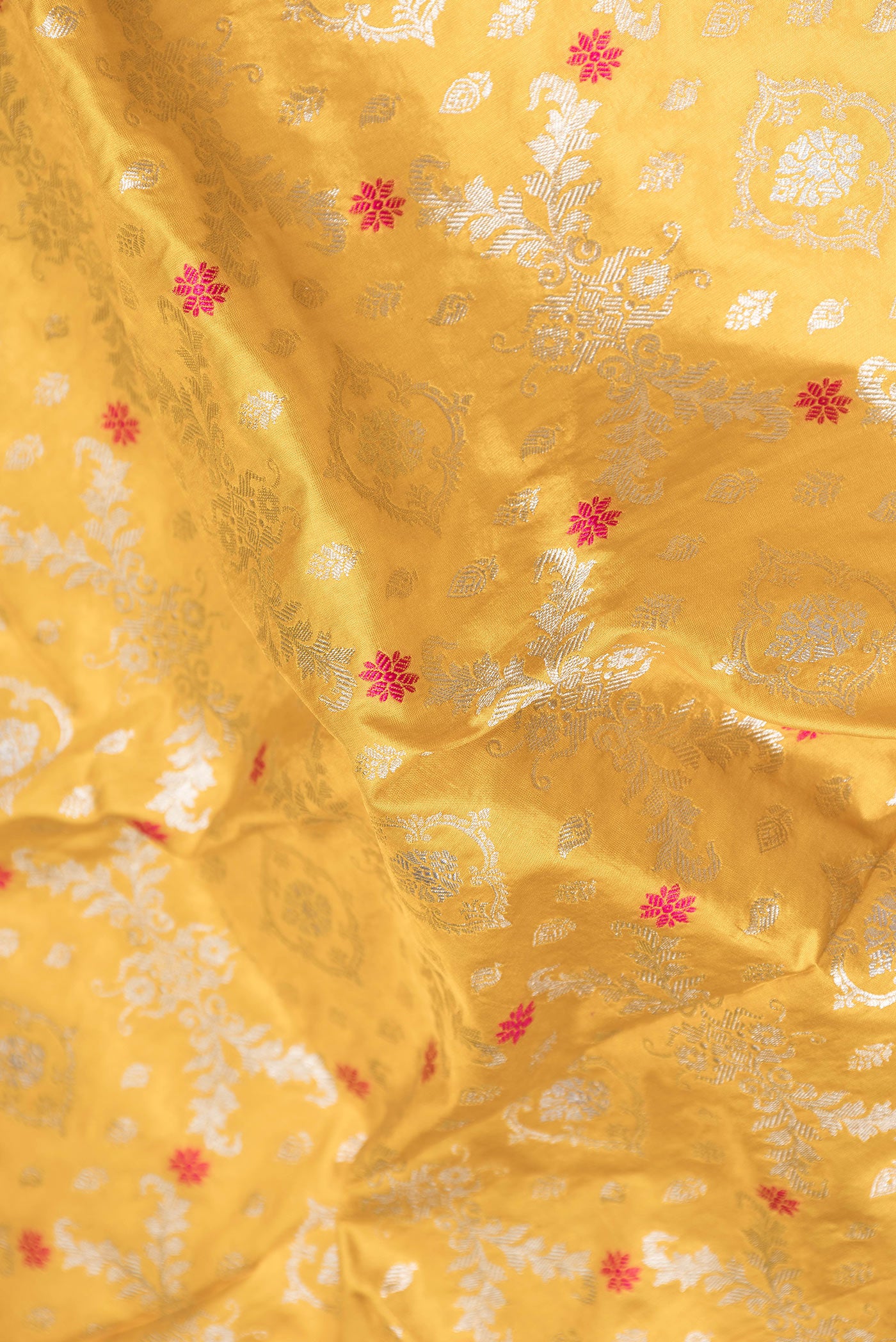 Close up of Mustard Dual Tone Banarasi Silk Saree with Zari Brocade on the body and Zari Border.  displaying folds