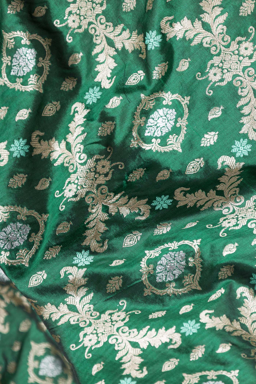 Close up of Bottle Green Dual Tone Banarasi Silk Saree with Zari Brocade on the body and Zari Border.  displaying folds