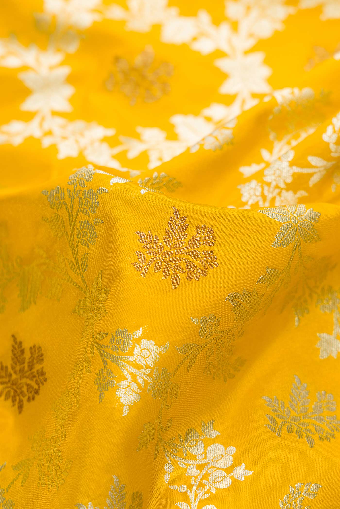 Close up of Yellow Dual Tone Blended Banarasi Silk Saree with Zari Brocade on the body and Zari Border.  displaying folds