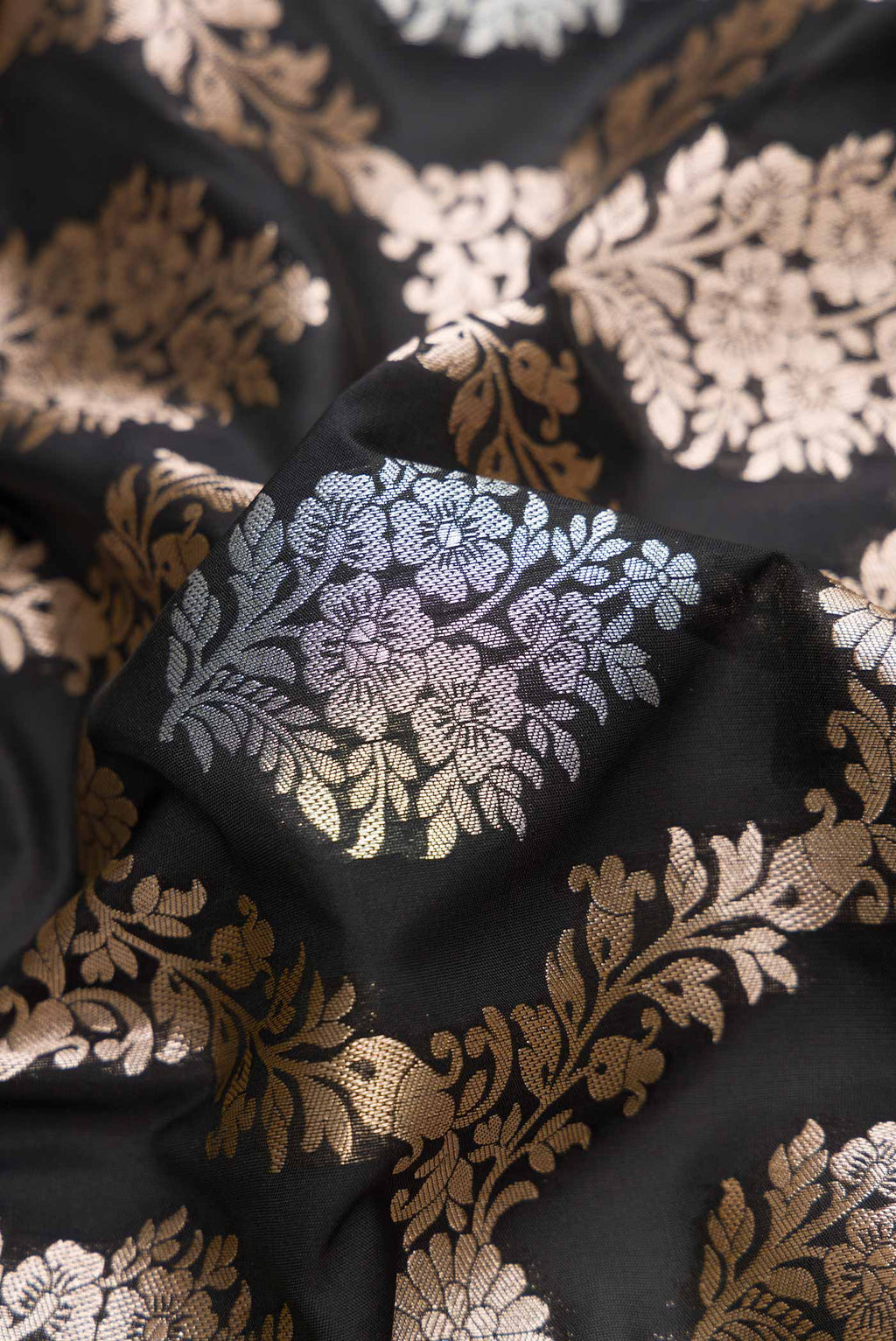 Close up of Black Dual Tone Blended Banarasi Silk Saree with Zari Brocade on the body and Zari Border.  displaying folds