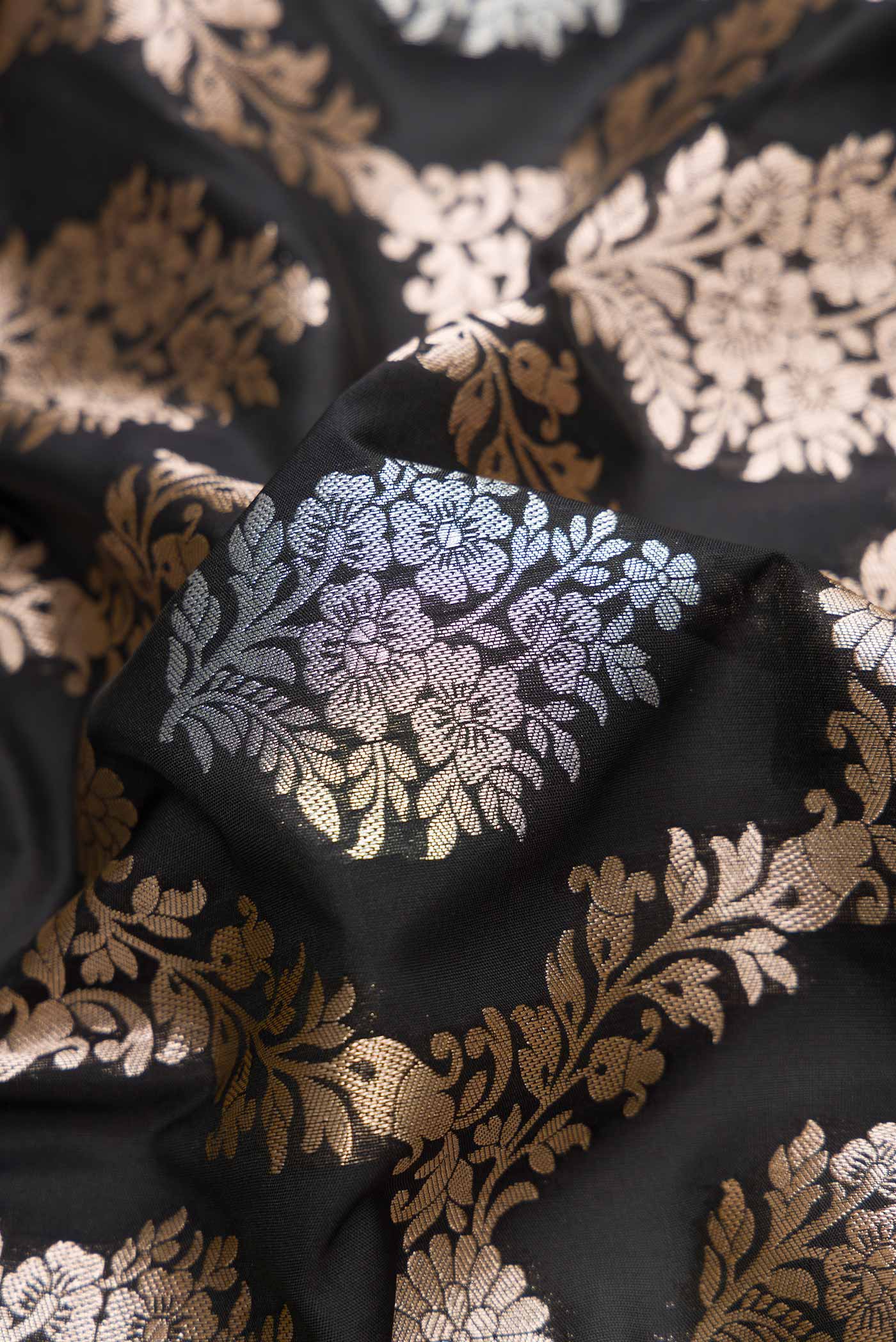 Close up of Black Dual Tone Blended Banarasi Silk Saree with Zari Brocade on the body and Zari Border.  displaying folds