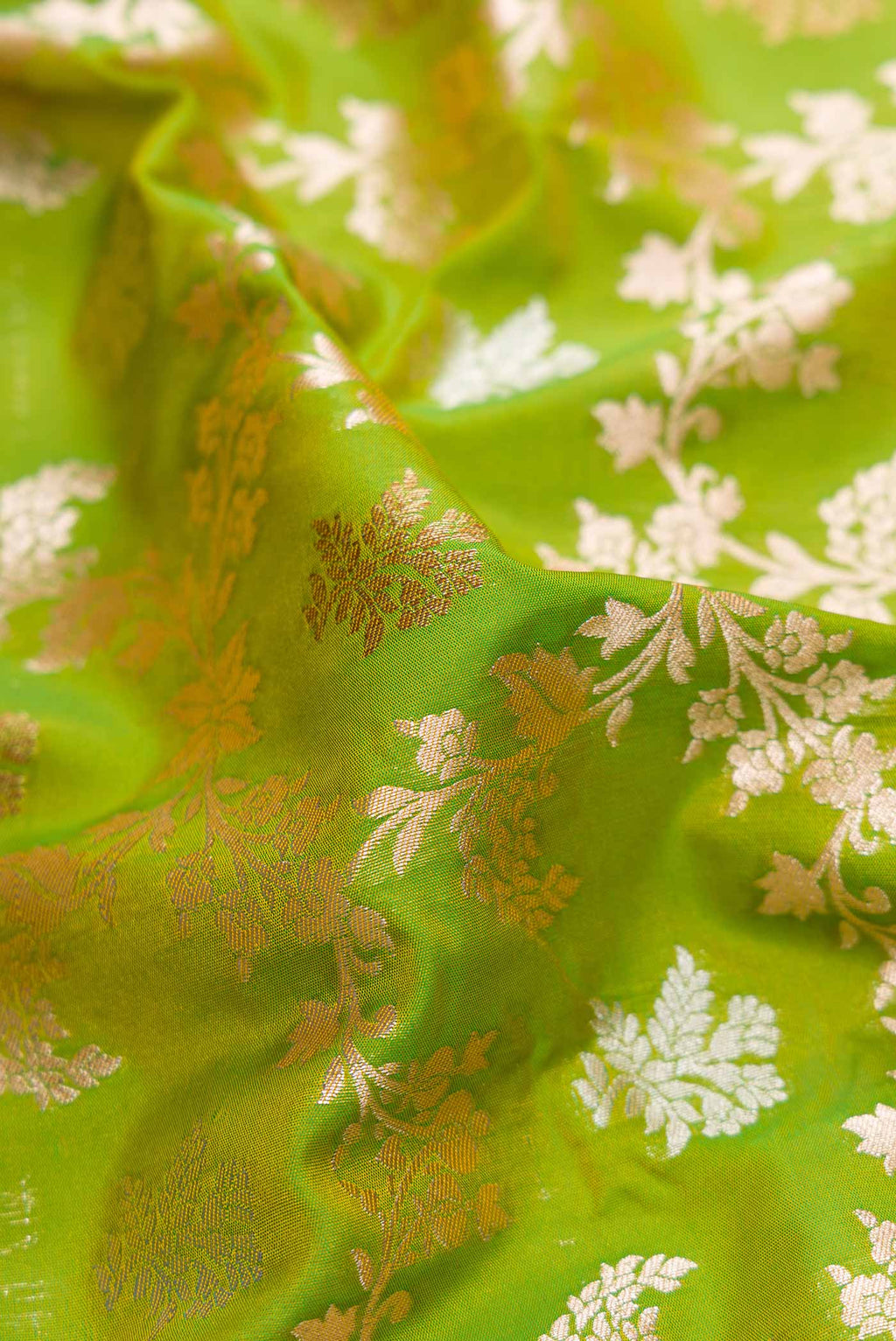 Close up of Green Dual Tone Blended Banarasi Silk Saree with Zari Brocade on the body and Zari Border.  displaying folds