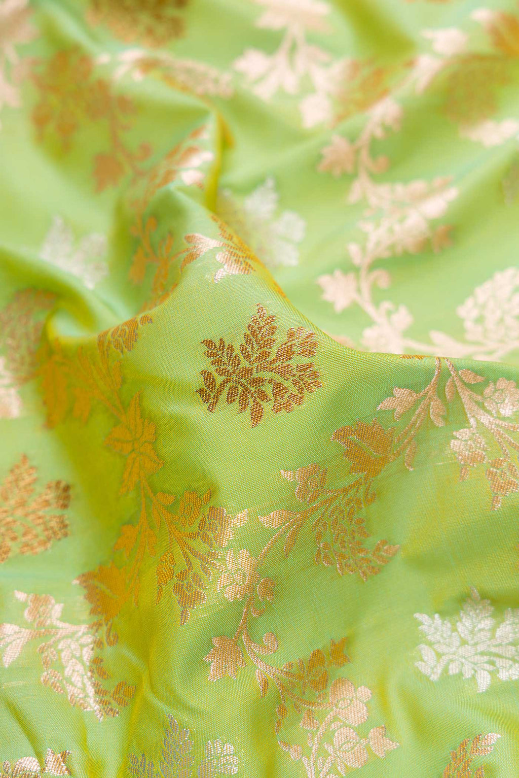Close up of Pista Green Dual Tone Blended Banarasi Silk Saree with Zari Brocade on the body and Zari Border.  displaying folds