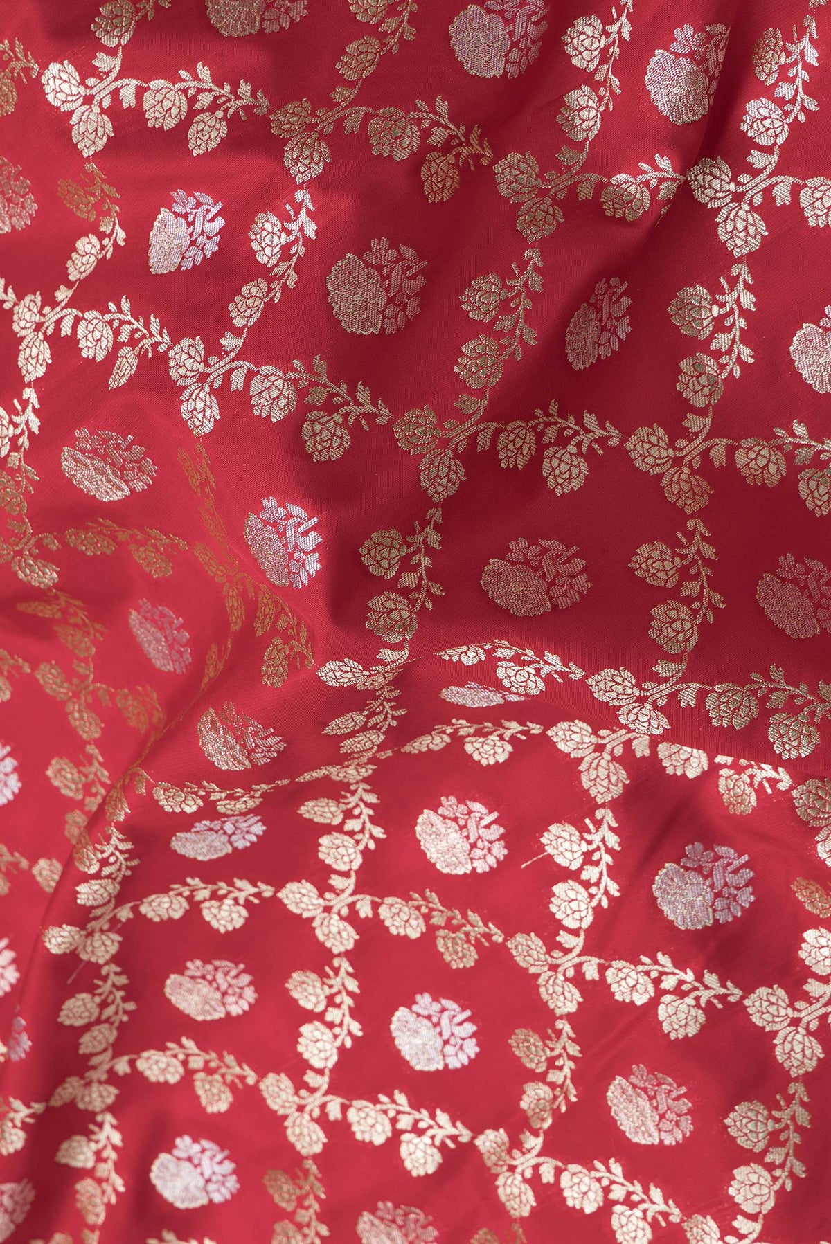 Close up of Red Dual Tone Banarasi Silk Saree with Zari Brocade on the body and Zari Border.  displaying folds