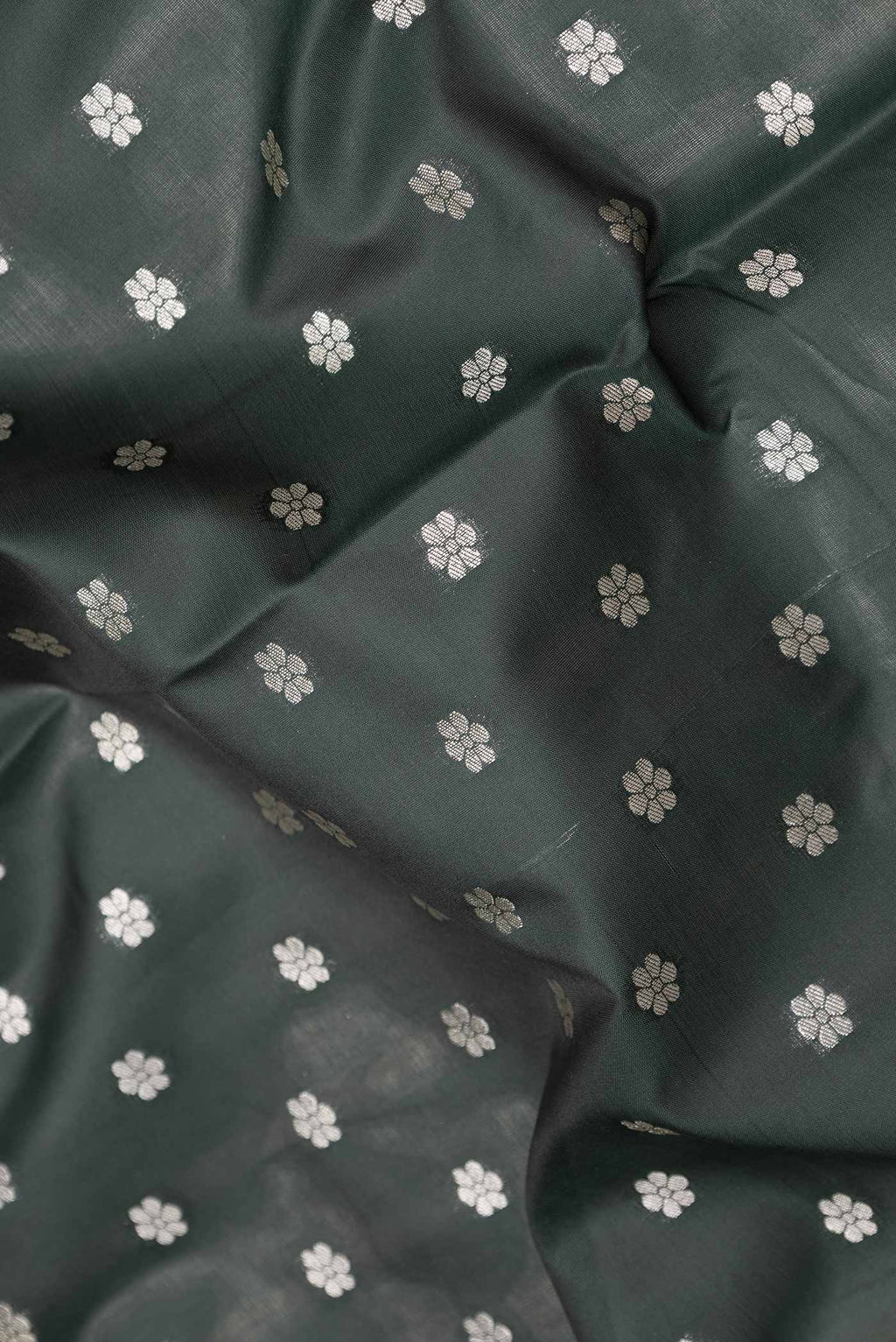 Close up of Bottle Green Dual Tone Blended Banarasi Saree with Zari Butta on the body and Zari Border.  displaying folds