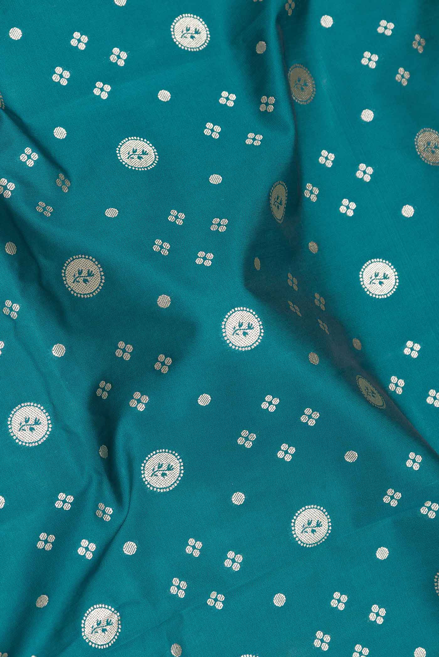 Close up of Peacock Blue Dual Tone Blended Banarasi Saree with Zari Butta on the body and Zari Border.  displaying folds
