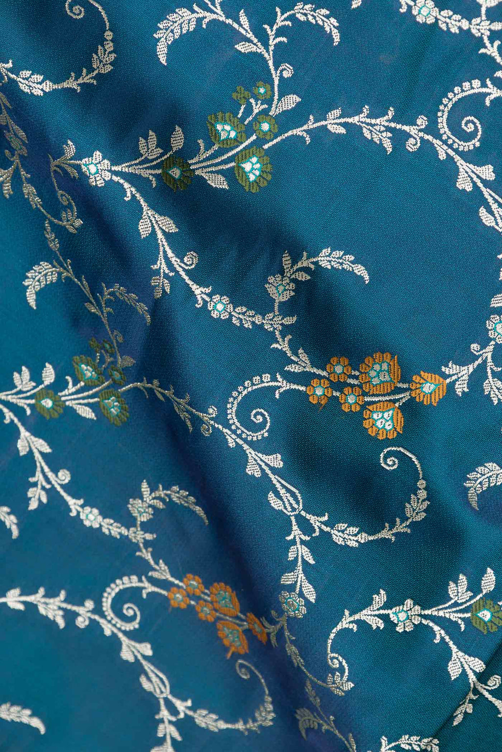 Close up of Peacock Blue Dual Tone Blended Banarasi Saree with Zari Brocade on the body and Zari Border.  displaying folds
