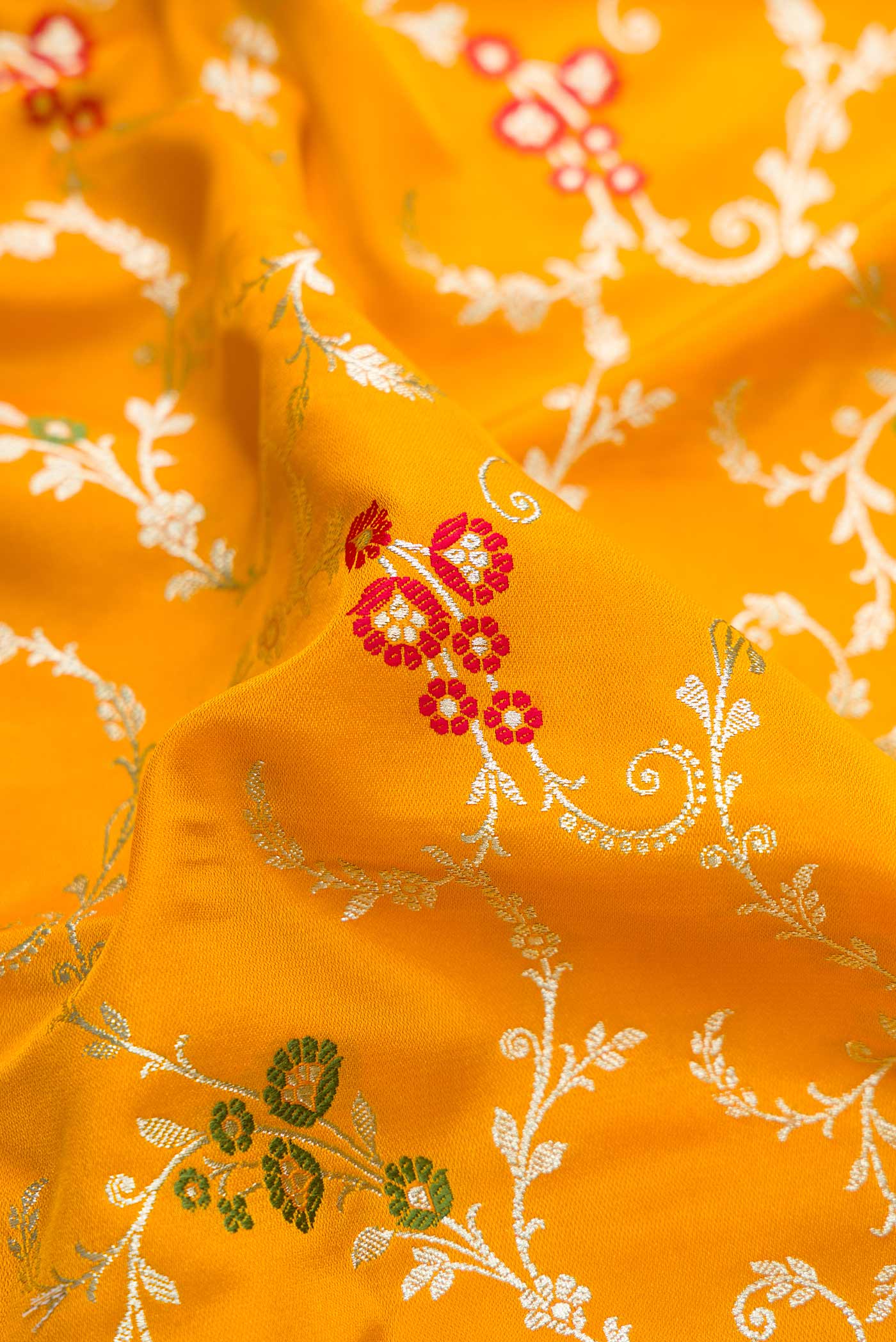 Close up of Mustard Dual Tone Blended Banarasi Silk Saree with Zari Brocade on the body and Zari Border.  displaying folds