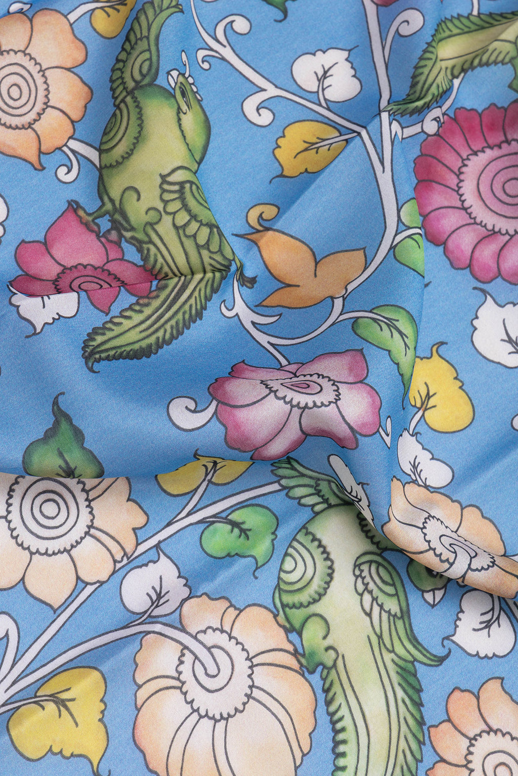 Close up of Blue Mysore Silk Saree with kalamkari Print on the body and Zari Border.  displaying folds