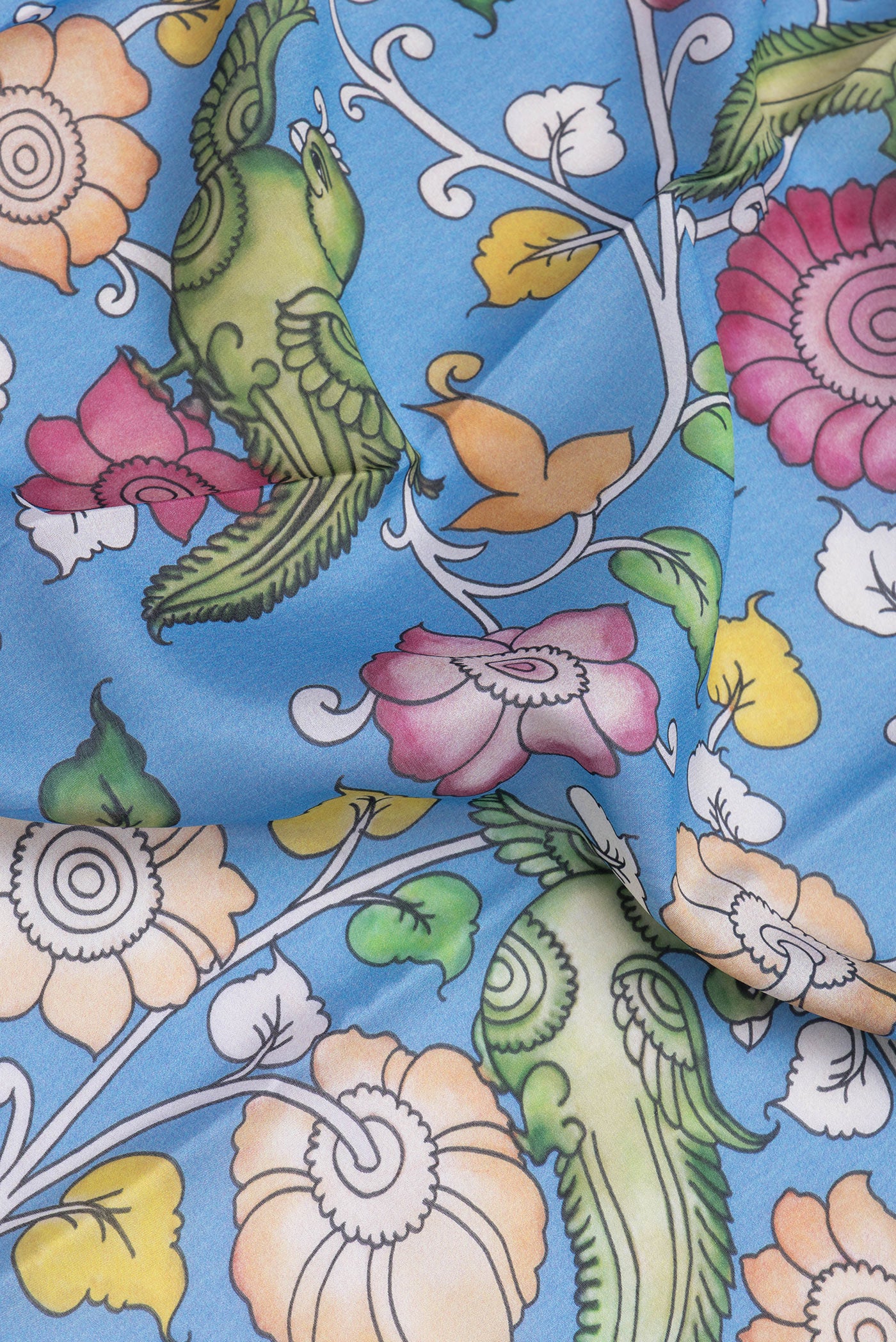 Close up of Blue Mysore Silk Saree with kalamkari Print on the body and Zari Border.  displaying folds